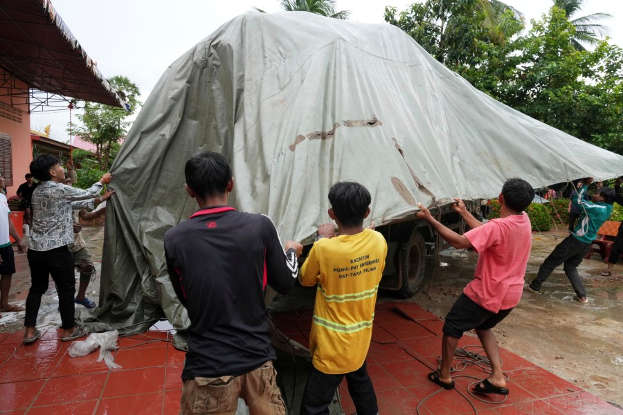 Local villagers help unloading supplies donated by a charity for refugees from a truck, in Srey Snam district, Siem Reap province, Cambodia, Monday, July 28, 2025, amid the fighting between Thailand and Cambodia. (AP Photo/Heng Sinith)