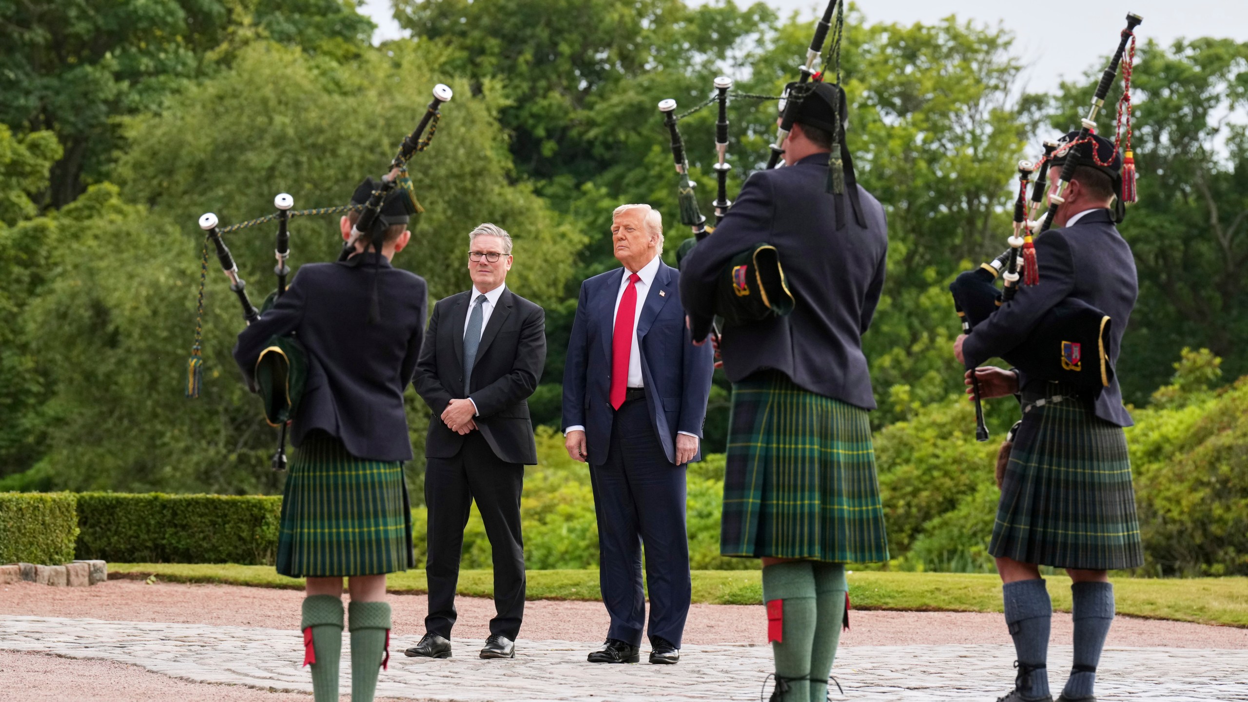 President Donald Trump, third right, and Britain's Prime Minister Keir Starmer, fourth right, are welcomed at Trump International Golf Links, near Aberdeen, Scotland, Monday, July 28, 2025. (AP Photo/Jacquelyn Martin)
