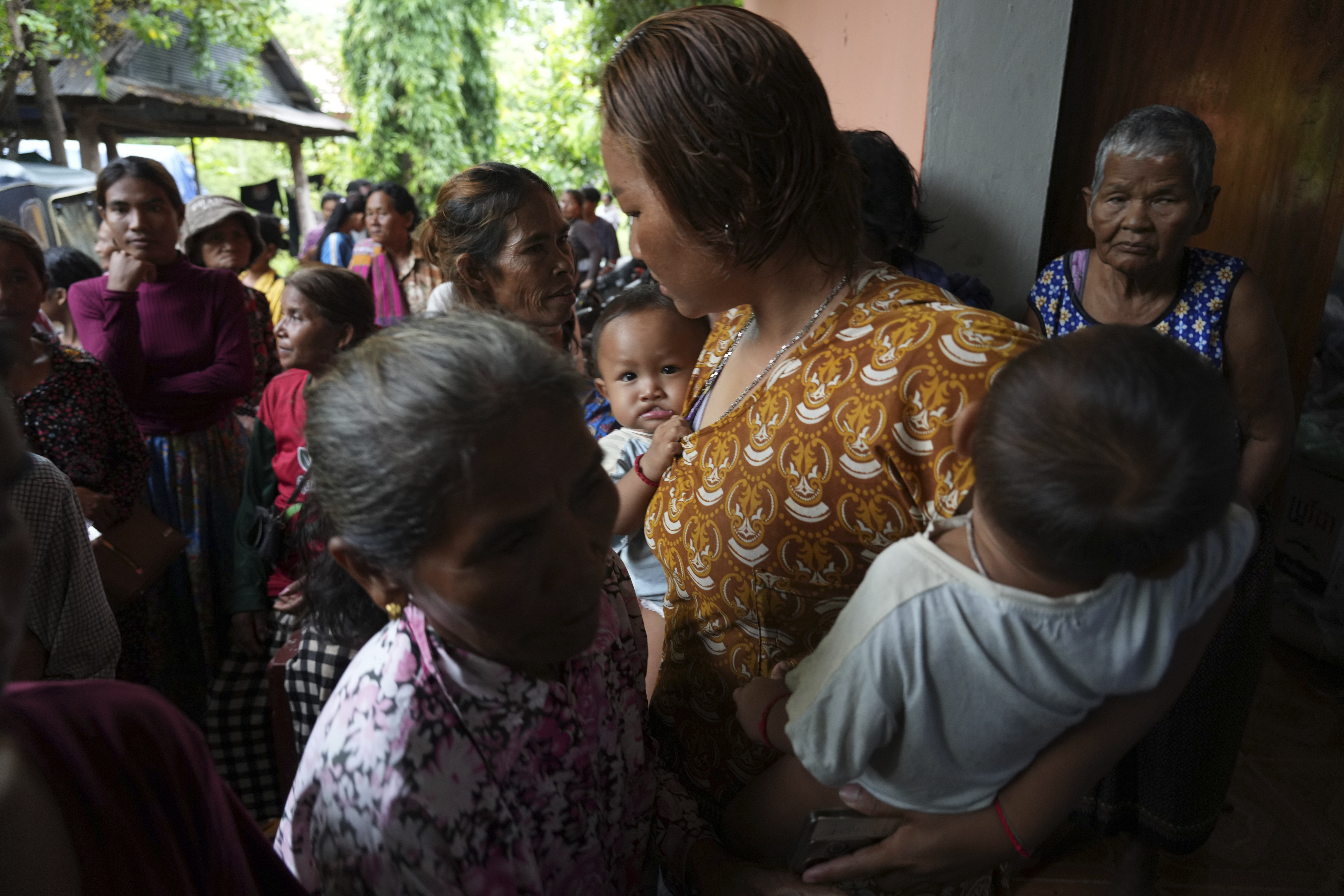 Local villagers wait to receive supplies donated by a charity, in Srey Snam district, Siem Reap province, Cambodia, Monday, July 28, 2025, amid the fighting between Thailand and Cambodia. (AP Photo/Heng Sinith)
