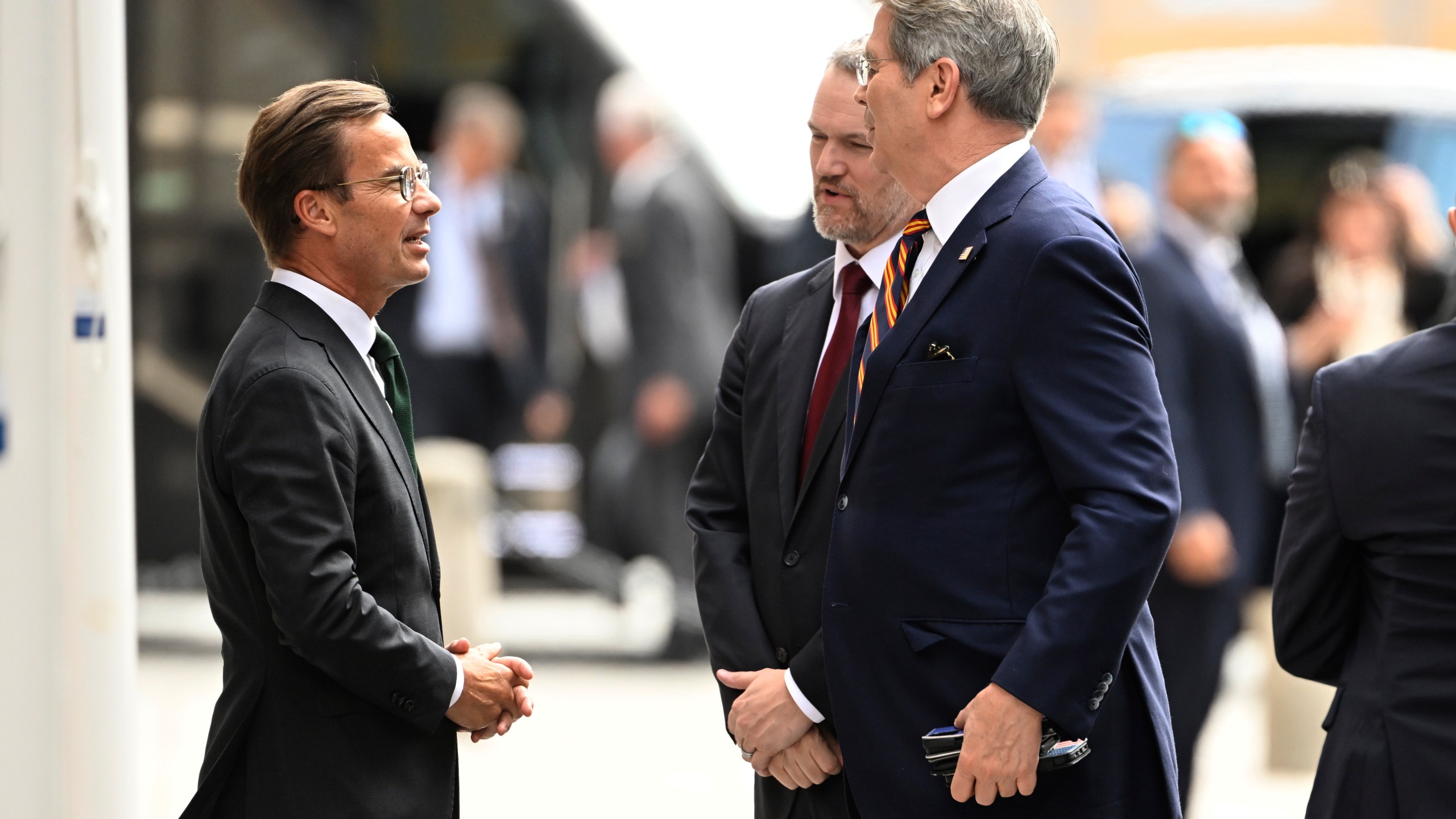 Swedens prime minister Ulf Kristersson, left, greets US treasury secretary Scott Bessent, right, and US trade representative Jamieson Greer, second right, outside Rosenbad ahead of trade talks between the US and China in Stockholm, Sweden, July 28, 2025. (Fredrik Sandberg/TT News Agency via AP)