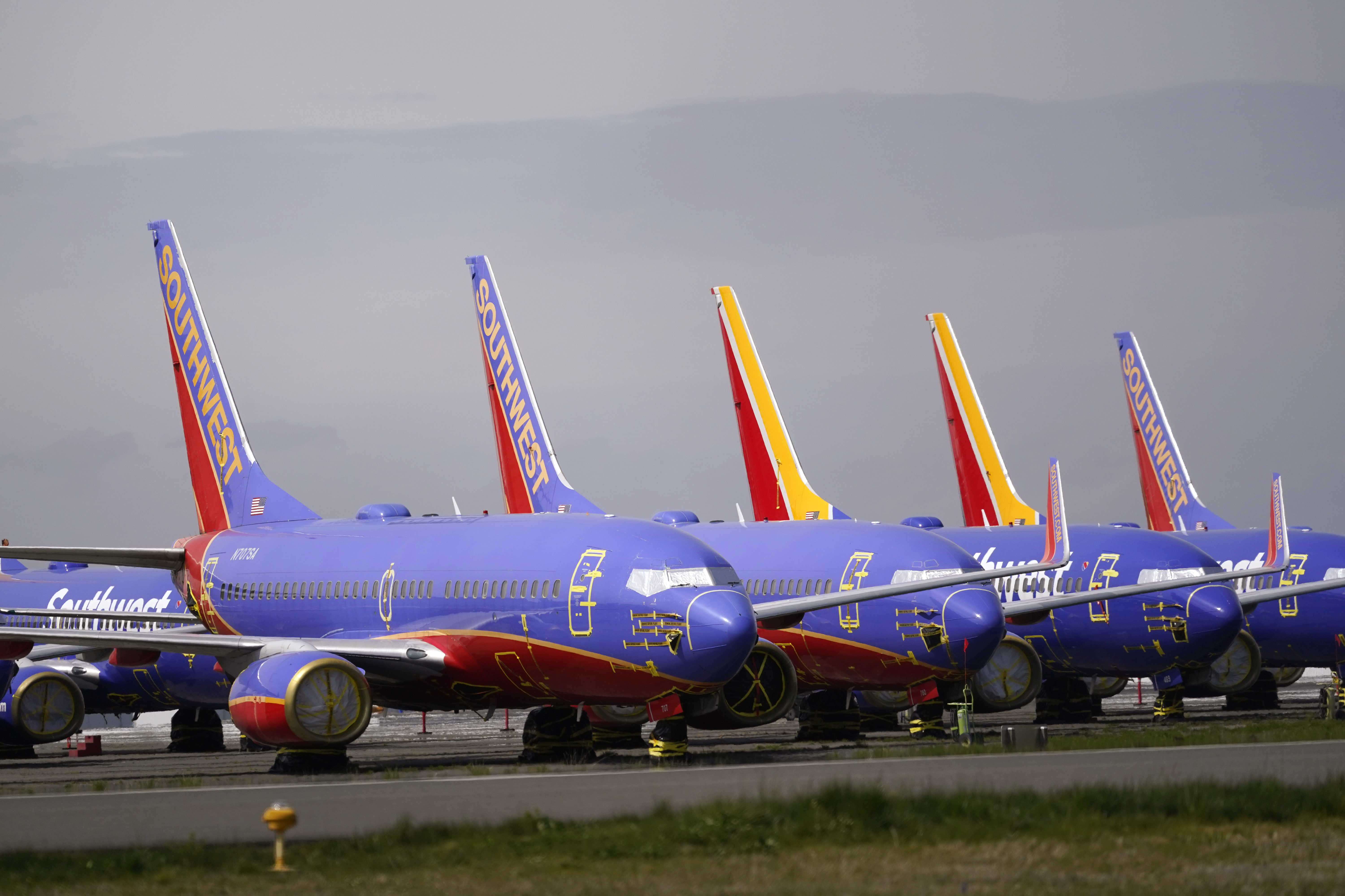 FILE - A line of Southwest Air Boeing 737 jets are parked near the company's production plant while being stored at Paine Field Friday, April 23, 2021, in Everett, Wash. (AP Photo/Elaine Thompson, File)