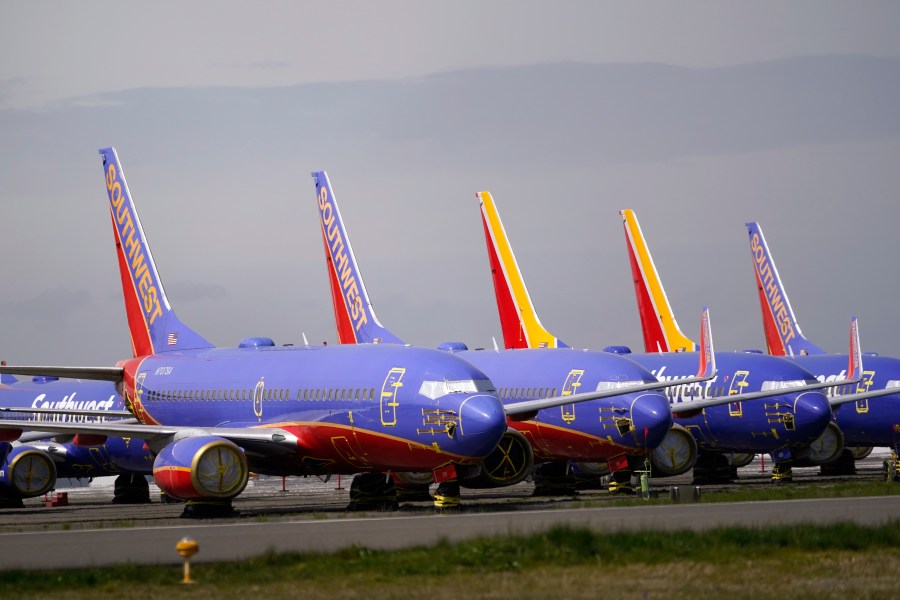 FILE - A line of Southwest Air Boeing 737 jets are parked near the company's production plant while being stored at Paine Field Friday, April 23, 2021, in Everett, Wash. (AP Photo/Elaine Thompson, File)