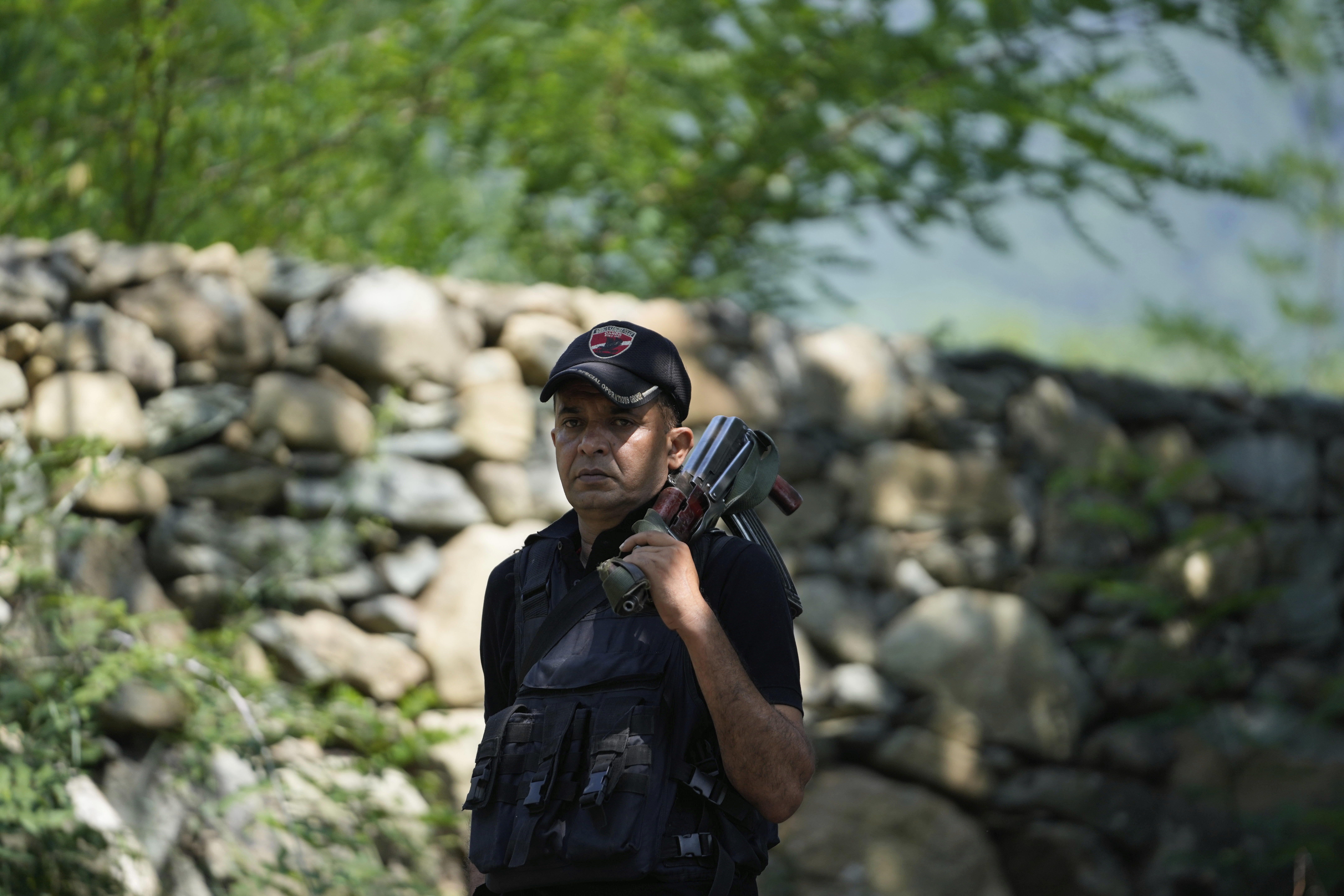 Jammu and Kashmir Special Operation Group (SOG) personnel guard near the site of a gun battle on the outskirts of Srinagar, Indian controlled Kashmir, Monday, July 28, 2025. (AP Photo/Mukhtar Khan)