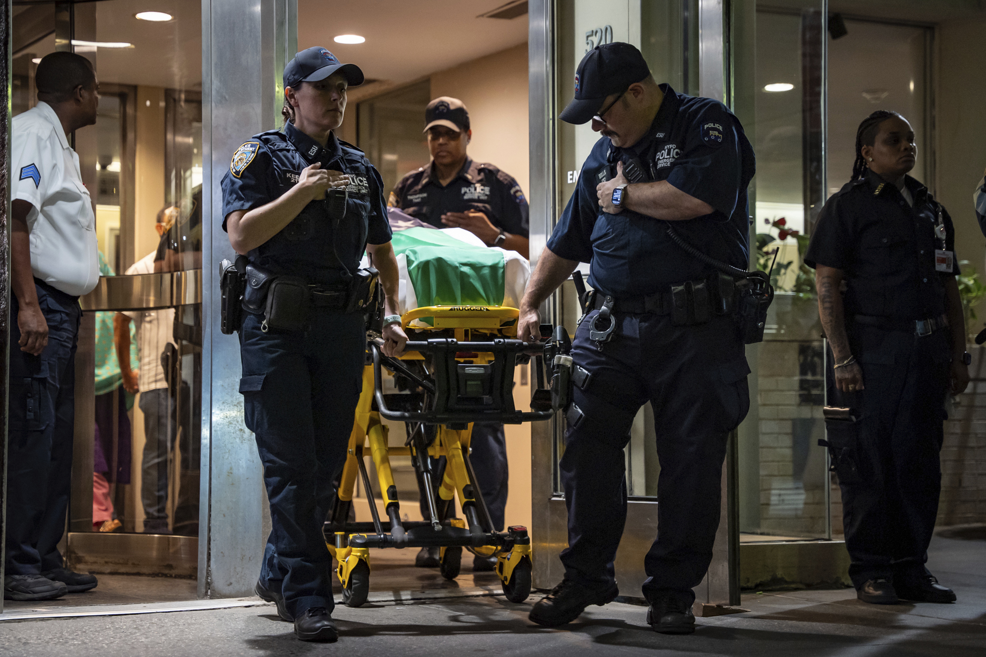 NYPD officers bring out the body of Didarul Islam, who was shot and killed by a gunman earlier this evening, during his dignified transfer of out of NewYork-Presbyterian/Weill Cornell Medical Hospital to the medical examiner's office, early Tuesday, July 29, 2025, in New York. (AP Photo/Angelina Katsanis)
