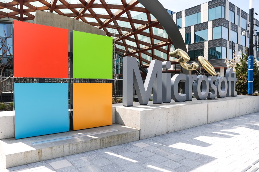 FILE - A Microsoft sign and logo are pictured at the company's headquarters, Friday, April 4, 2025, in Redmond, Wash. (AP Photo/Jason Redmond, File)