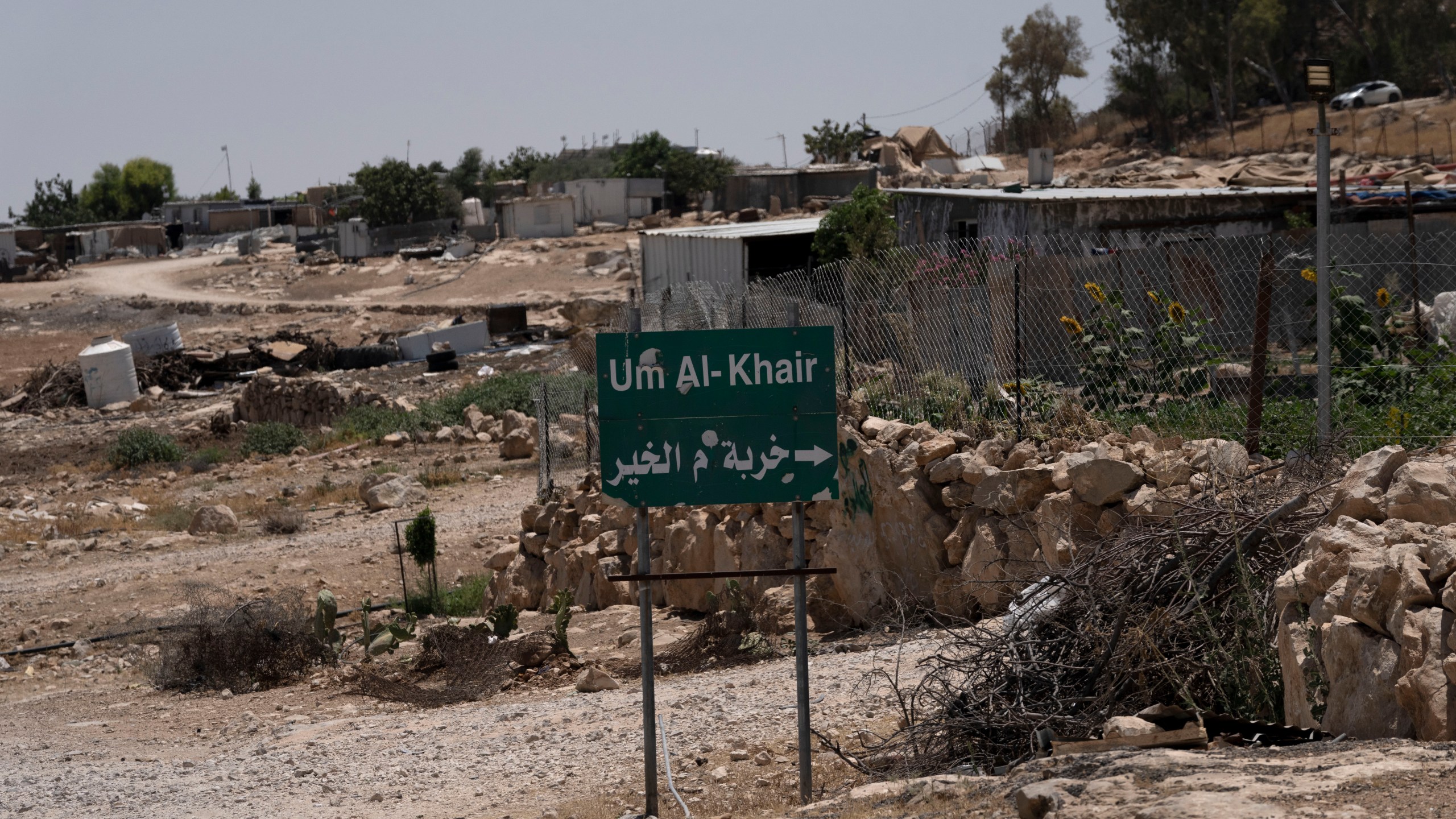 FILE - Caravans and simple structures for residents of the West Bank Bedouin village of Umm al-Khair, are seen at the entrance on July 10, 2024. (AP Photo/Maya Alleruzzo, File)