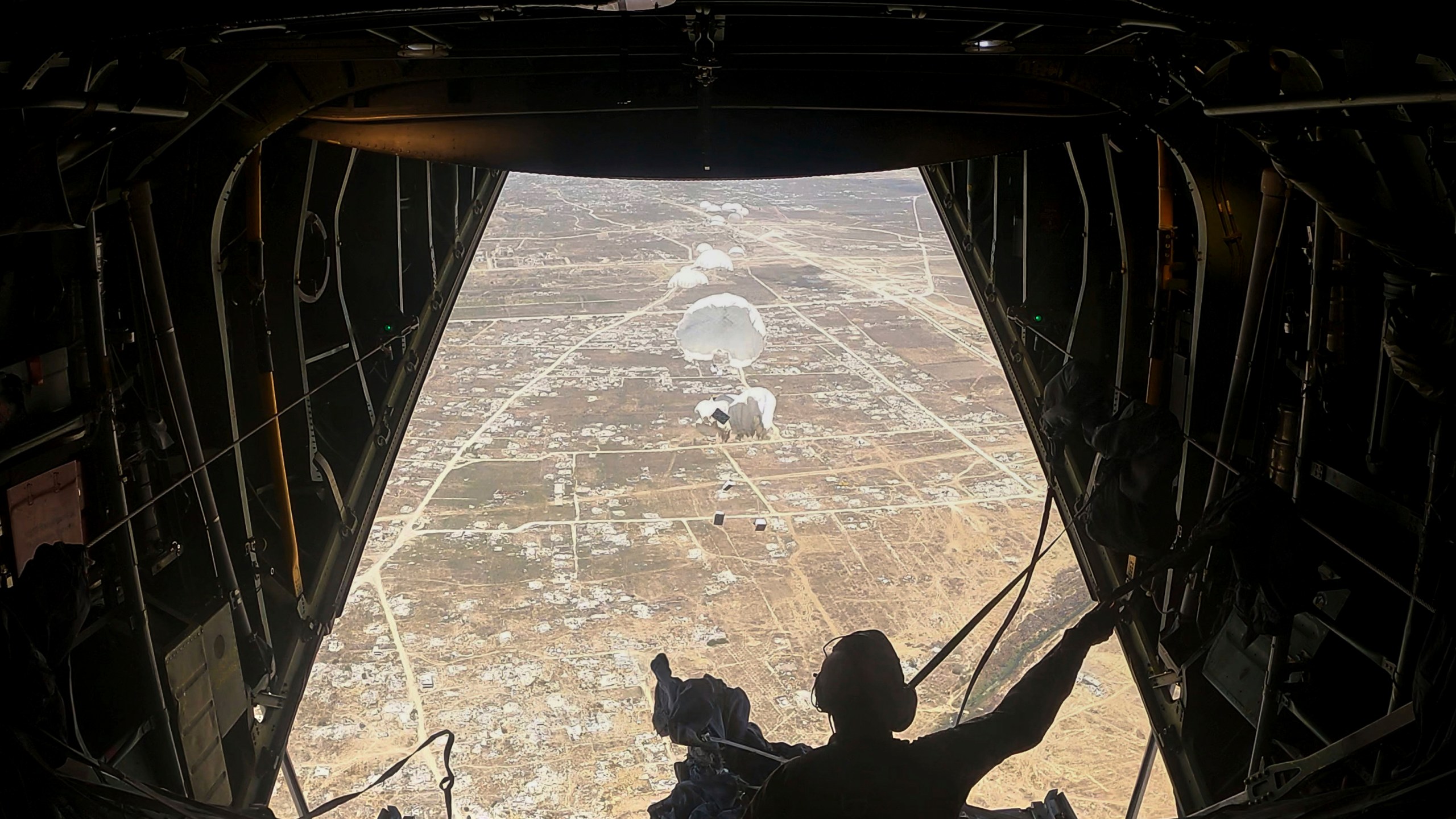 Humanitarian aid destined for Palestinians is airdropped over the Gaza Strip by a Jordanian Air Force aircraft on Tuesday, July 29, 2025. (AP Photo/Malak Harb)