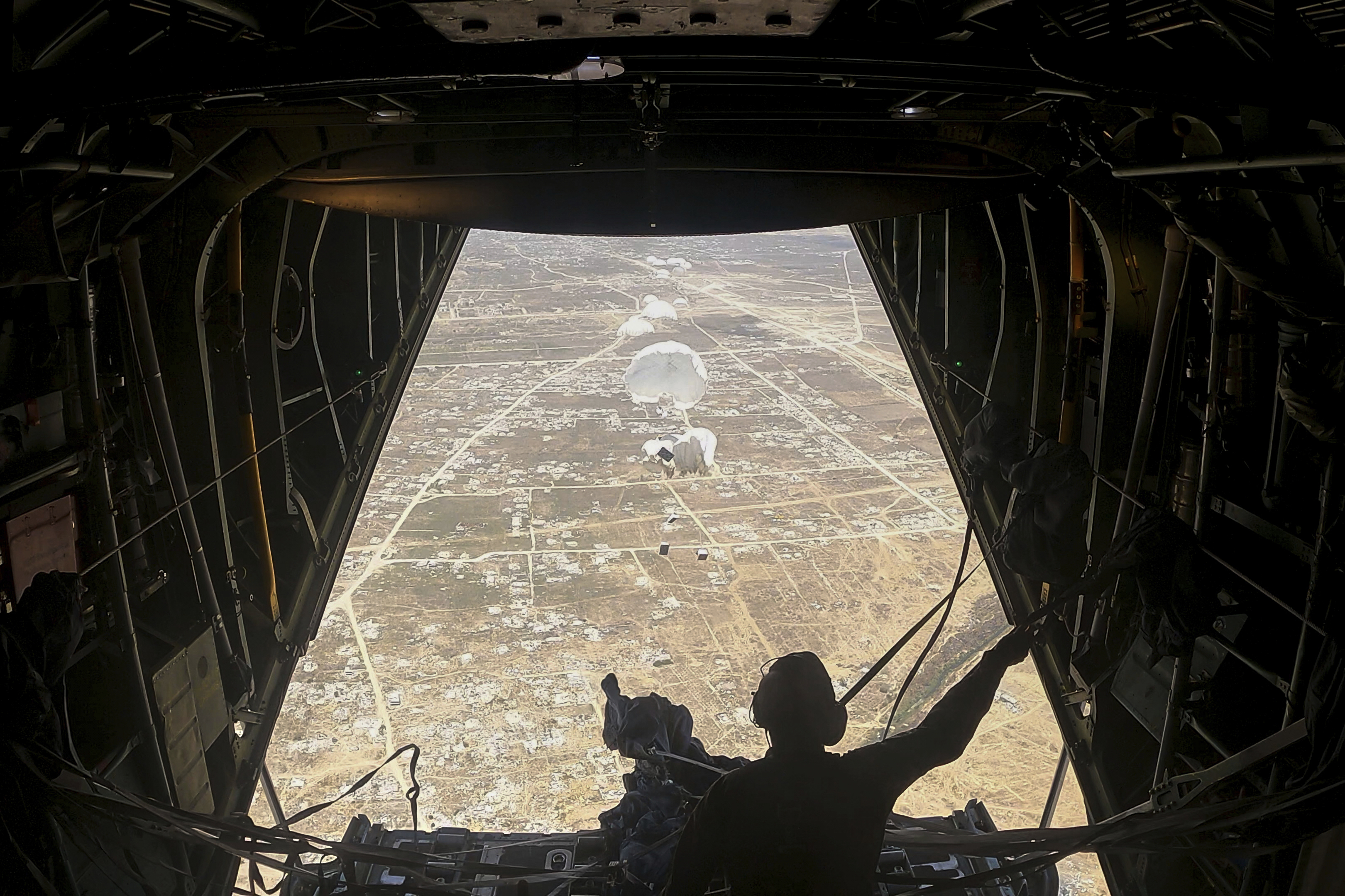 Humanitarian aid destined for Palestinians is airdropped over the Gaza Strip by a Jordanian Air Force aircraft on Tuesday, July 29, 2025. (AP Photo/Malak Harb)