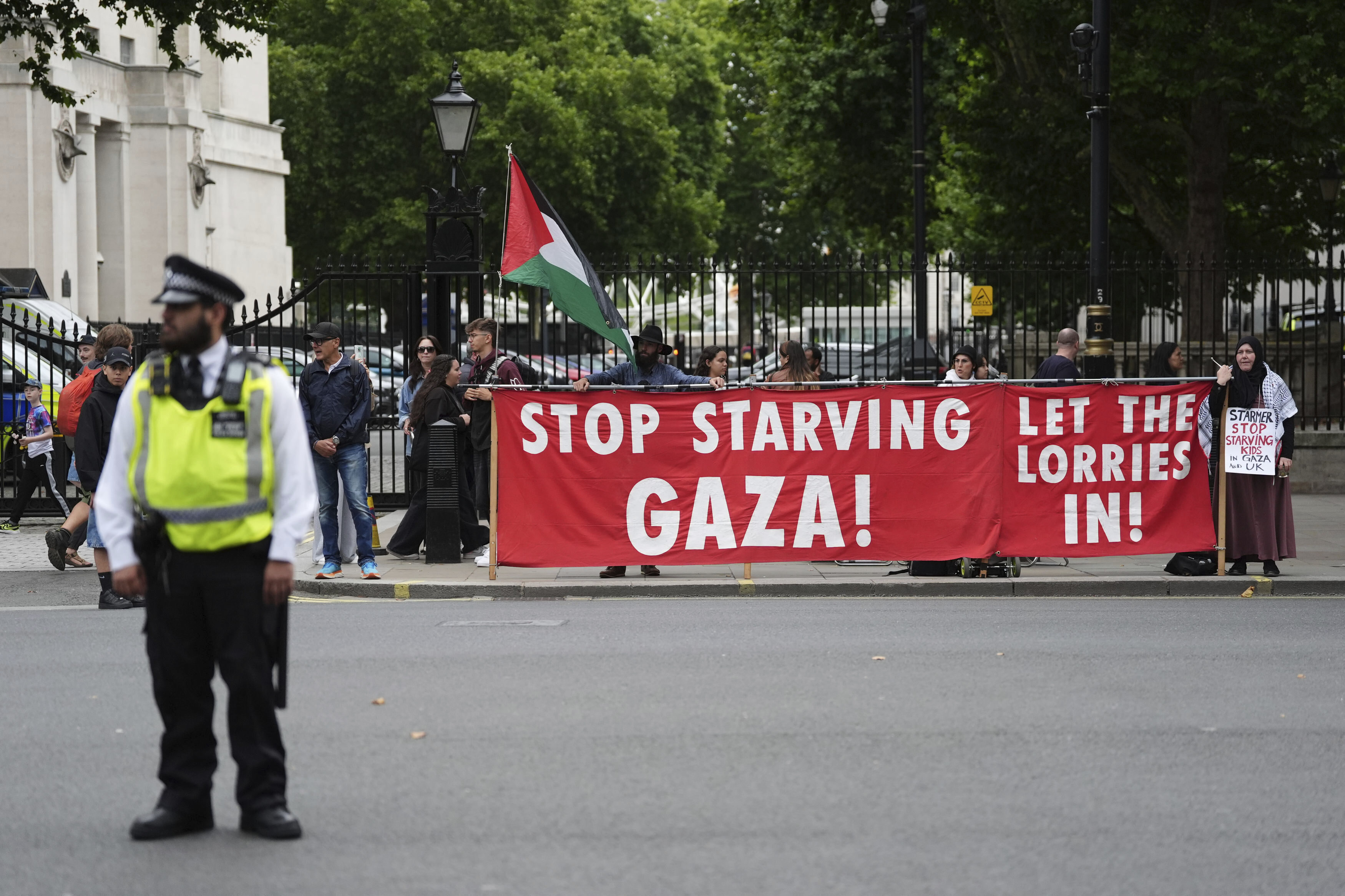 People take part in a protest outside Downing Street in London, Tuesday July 29, 2025, as Prime Minister Keir Starmer gathered senior ministers for an urgent Cabinet meeting on Gaza. (Jonathan Brady/PA via AP)