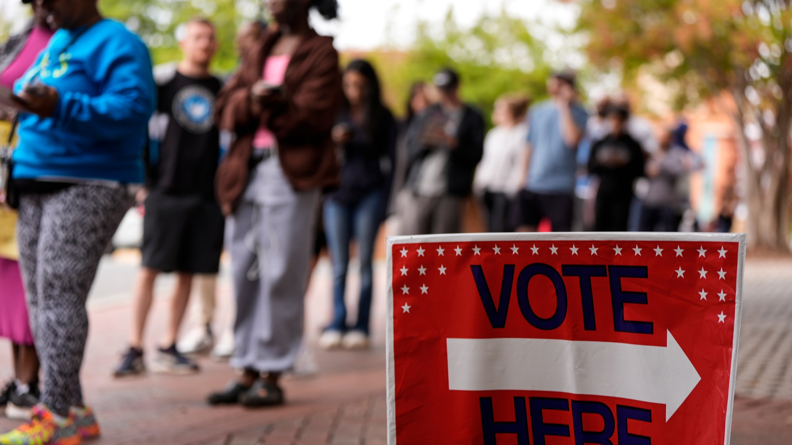 FILE - People stand in line during the last day of early voting, Saturday, Nov. 2, 2024, in Charlotte, N.C. (AP Photo/Mike Stewart, file)