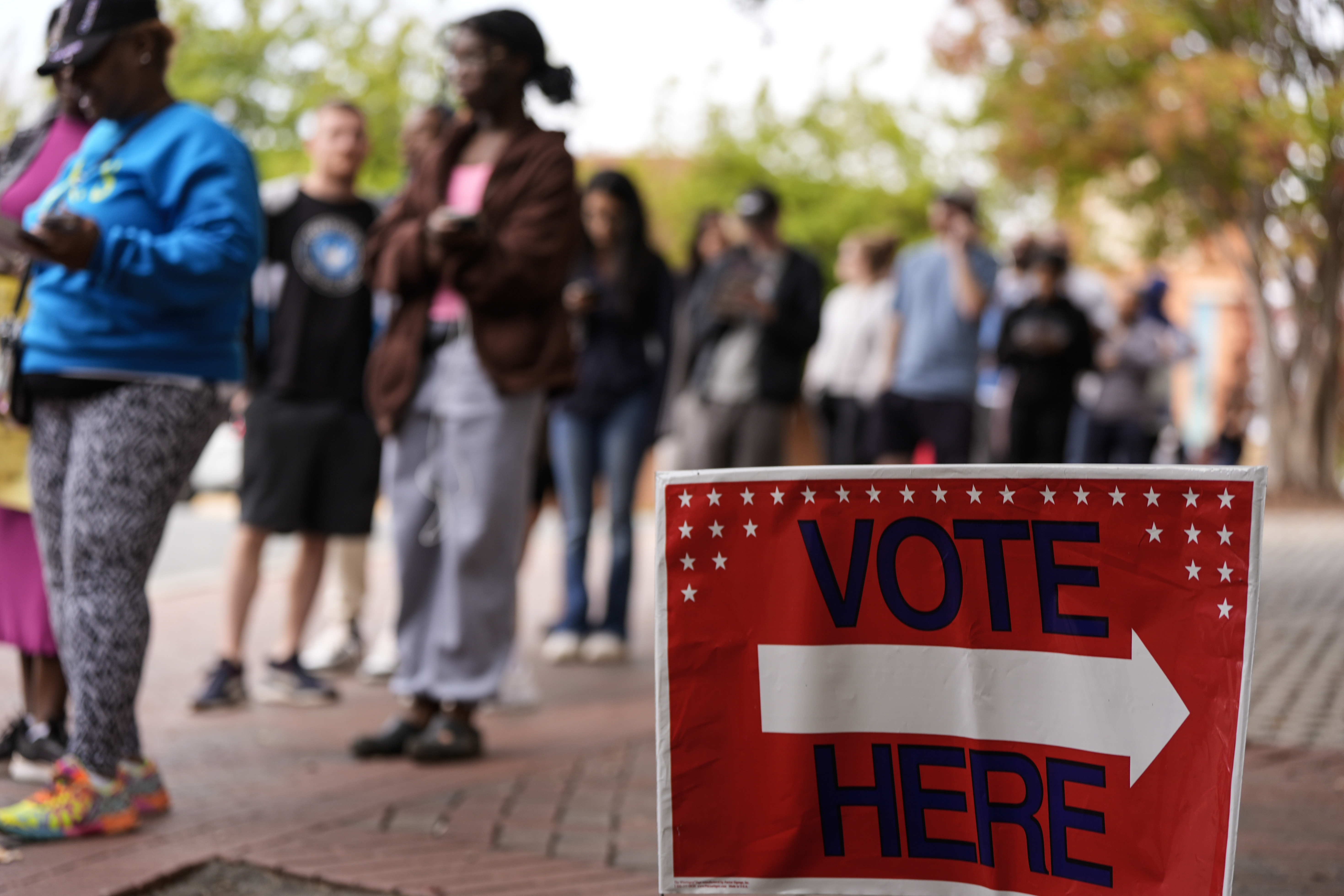 FILE - People stand in line during the last day of early voting, Saturday, Nov. 2, 2024, in Charlotte, N.C. (AP Photo/Mike Stewart, file)