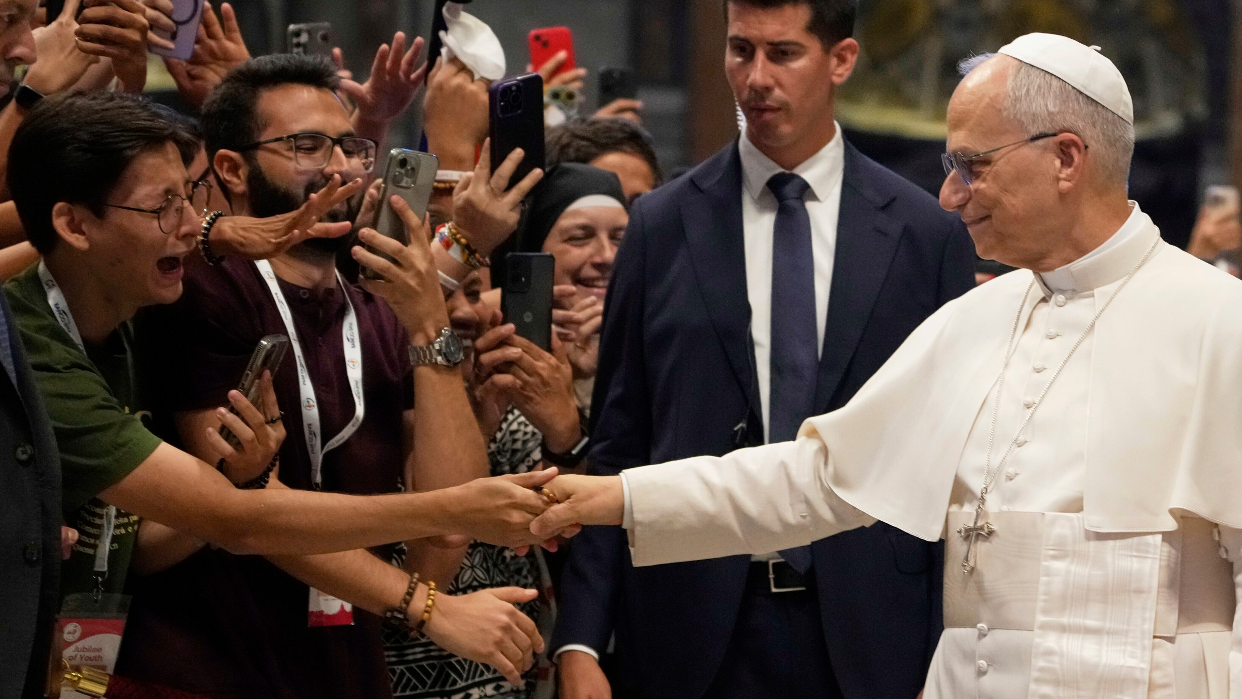 Pope Leo XIV greets faithful at the end of a mass celebrated by Cardinal Luis Antonio Tagle in St. Peter's Basilica on the occasion of the Youth Jubilee at the Vatican, Tuesday, July 29, 2025. (AP Photo/Gregorio Borgia)