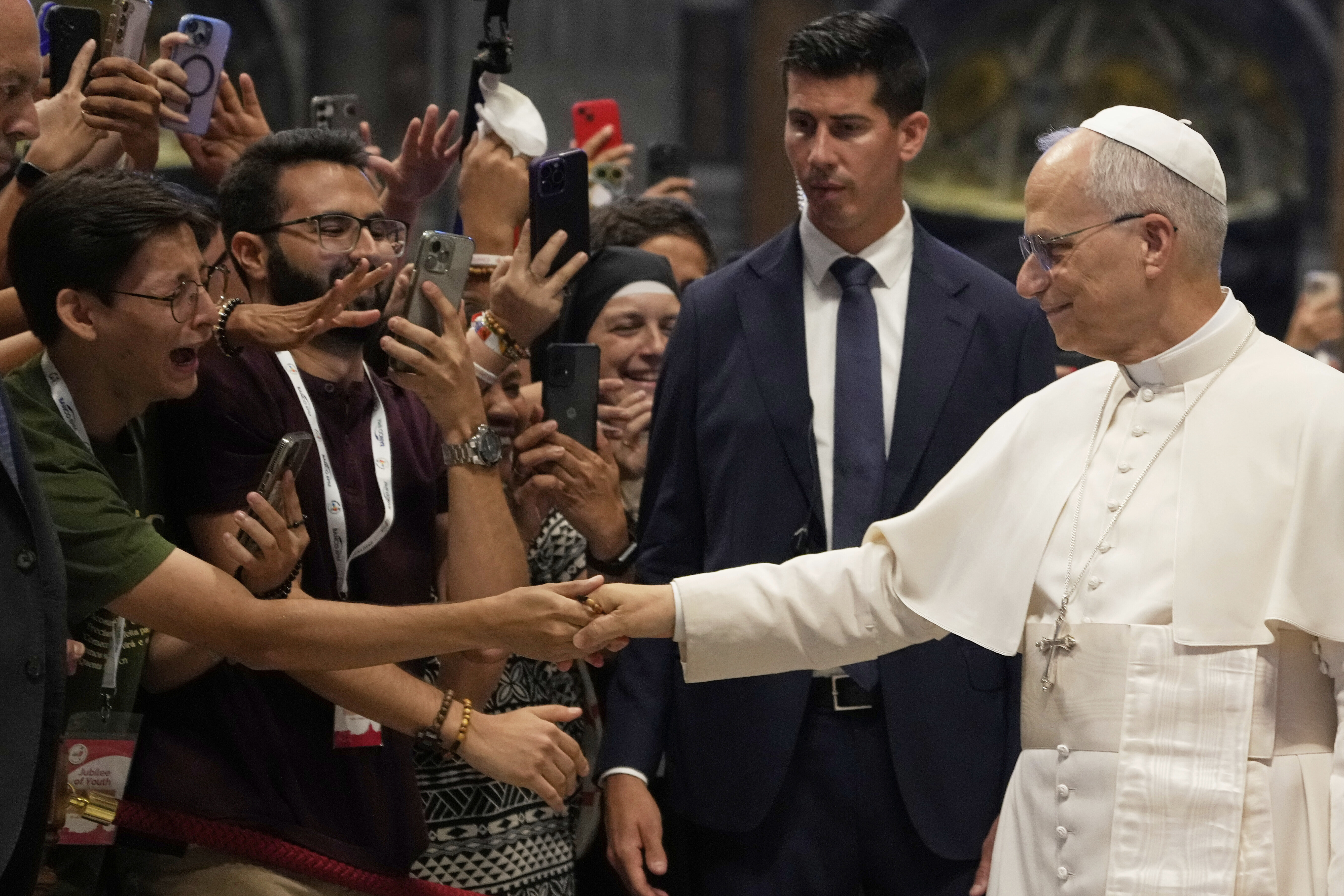 Pope Leo XIV greets faithful at the end of a mass celebrated by Cardinal Luis Antonio Tagle in St. Peter's Basilica on the occasion of the Youth Jubilee at the Vatican, Tuesday, July 29, 2025. (AP Photo/Gregorio Borgia)