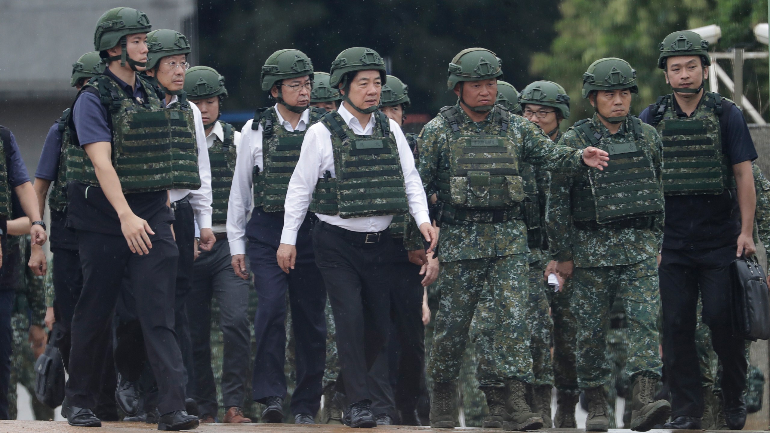 Taiwan President Lai Ching-te, center, inspects a live-fire shooting training in Hsinchu County, Taiwan, Thursday, July 10, 2025. (AP Photo/Chiang Ying-ying)