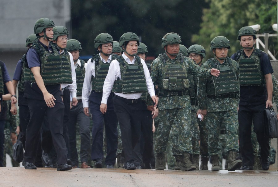 Taiwan President Lai Ching-te, center, inspects a live-fire shooting training in Hsinchu County, Taiwan, Thursday, July 10, 2025. (AP Photo/Chiang Ying-ying)