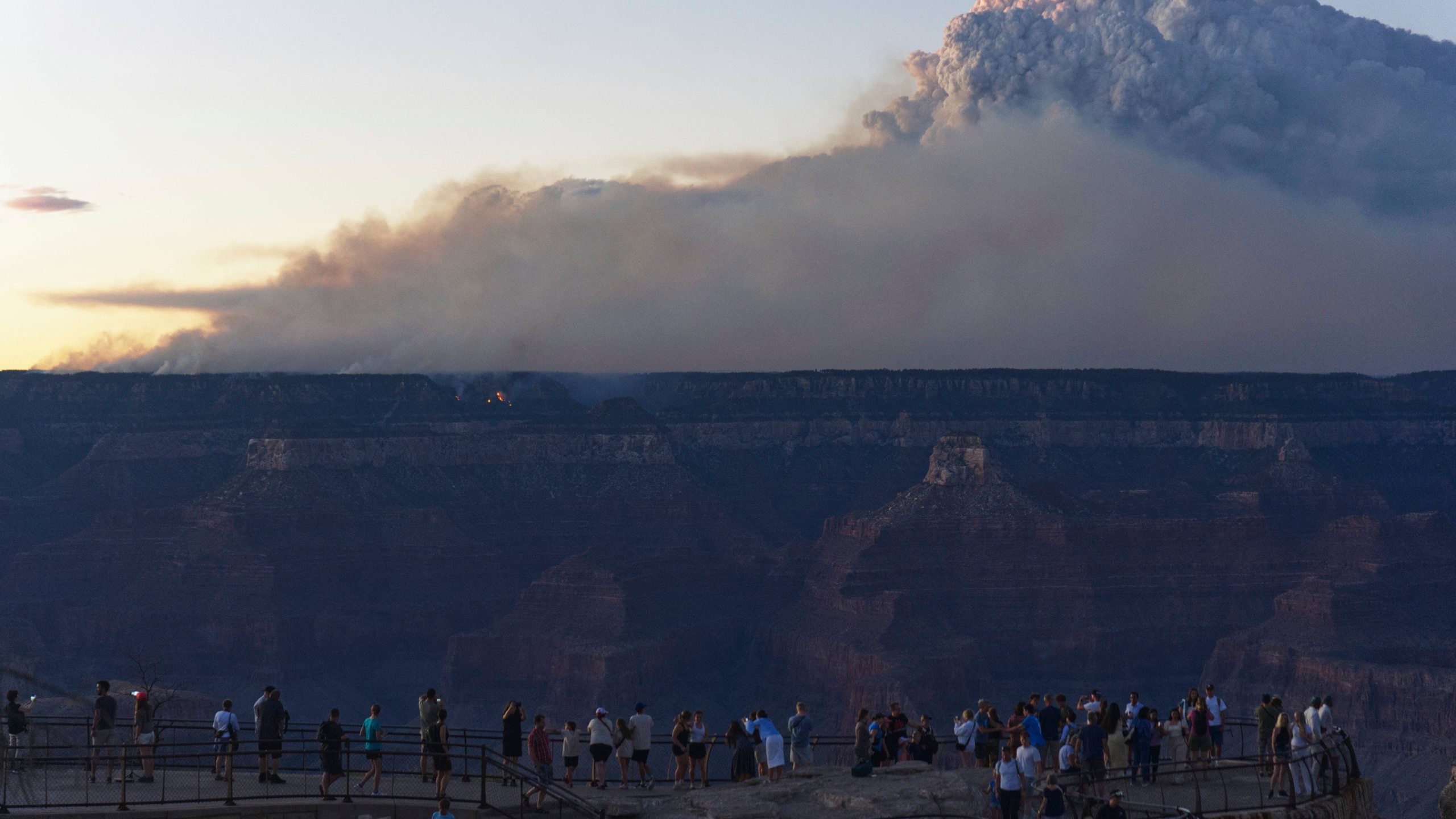 Smoke and a pyrocumulus cloud rises at sunset from the Dragon Bravo fire at the Grand Canyon as seen from Mather Point near Grand Canyon Village, Ariz., Monday, July 28, 2025. (AP Photo/Jon Gambrell)