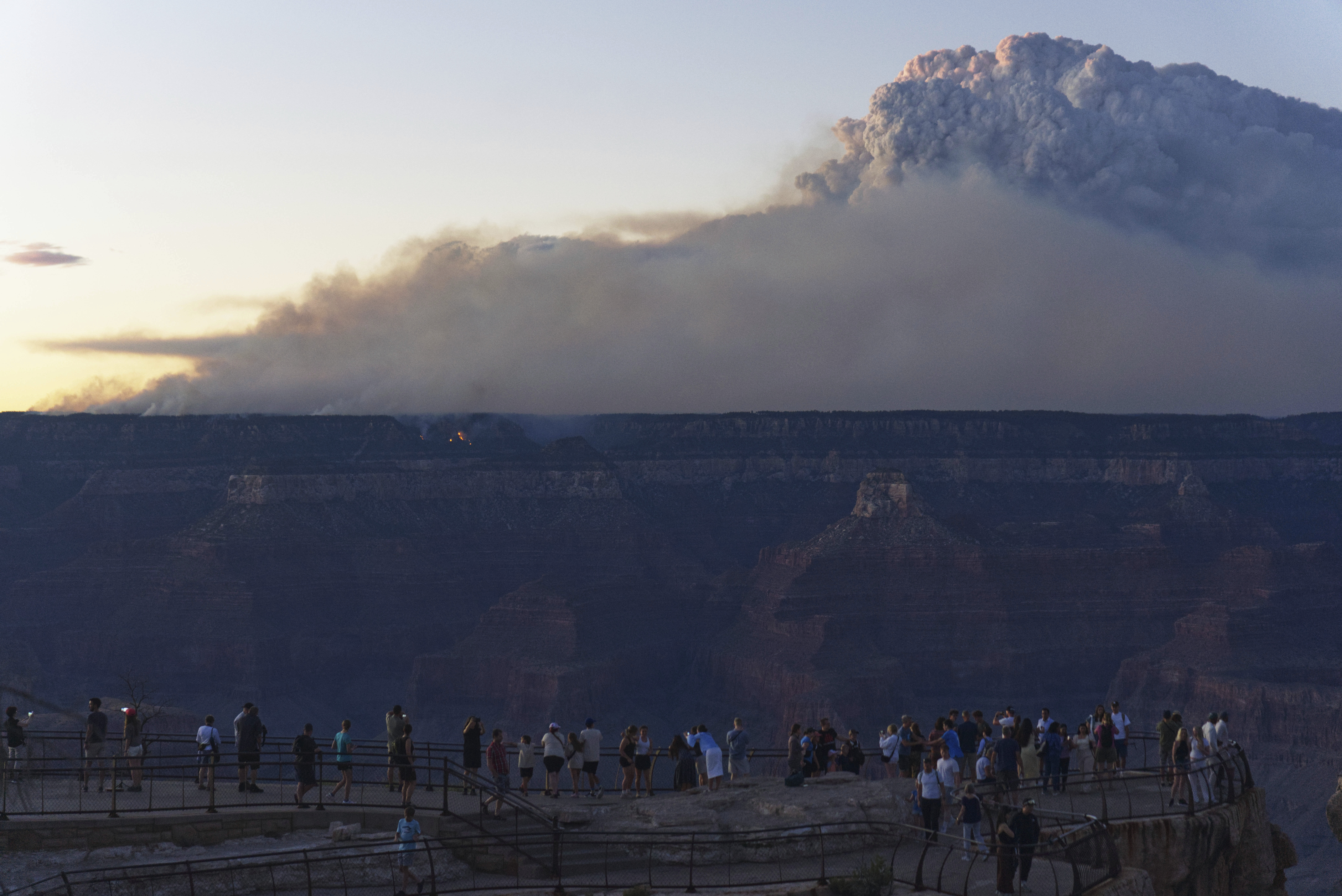 Smoke and a pyrocumulus cloud rises at sunset from the Dragon Bravo fire at the Grand Canyon as seen from Mather Point near Grand Canyon Village, Ariz., Monday, July 28, 2025. (AP Photo/Jon Gambrell)
