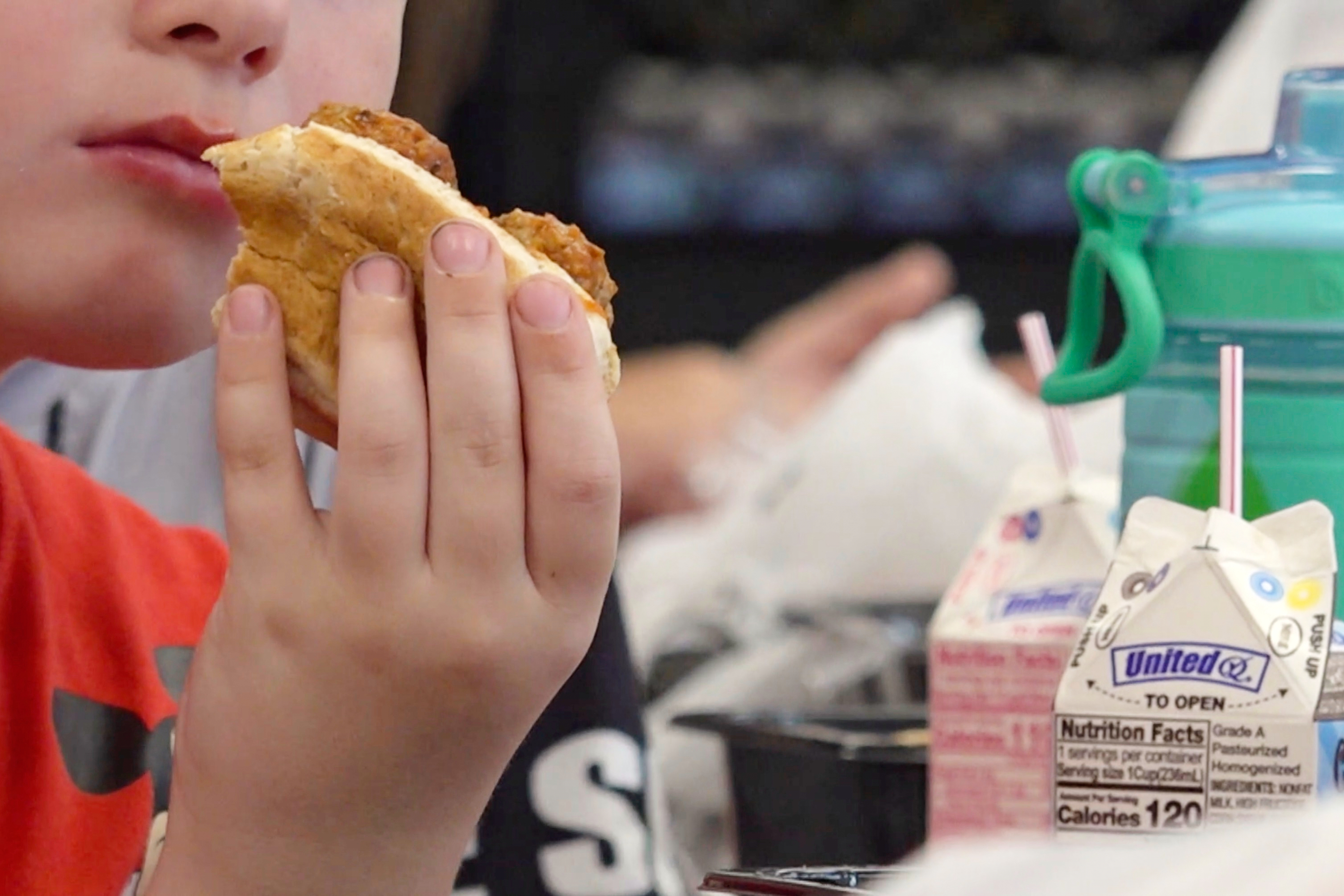 In this image from video, a student eats a meatball sub sandwich during lunch in Parkersburg, W.Va., on Wednesday, July 9, 2025. (AP Photo/Patrick Aftoora-Orsagos)