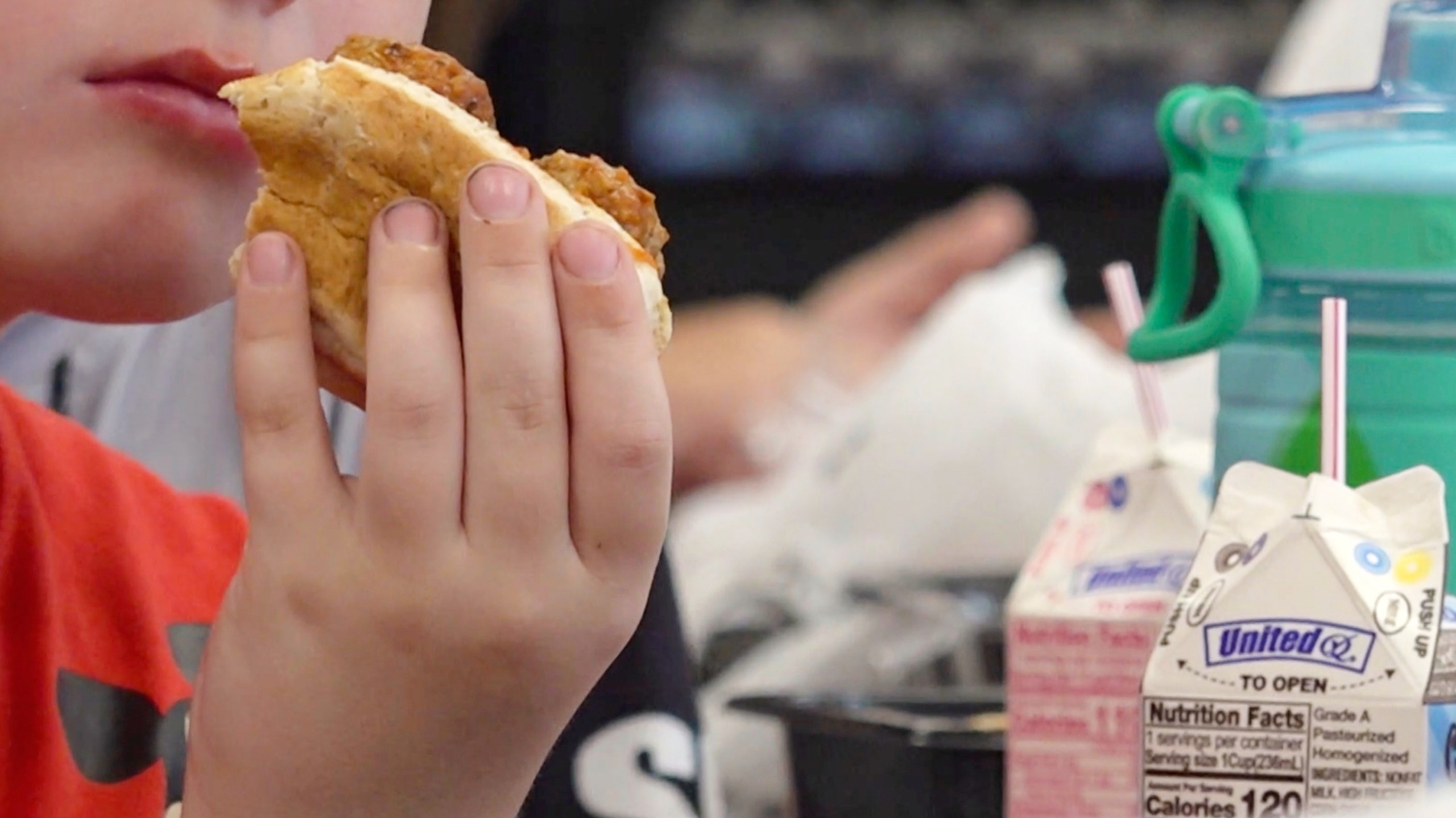 In this image from video, a student eats a meatball sub sandwich during lunch in Parkersburg, W.Va., on Wednesday, July 9, 2025. (AP Photo/Patrick Aftoora-Orsagos)