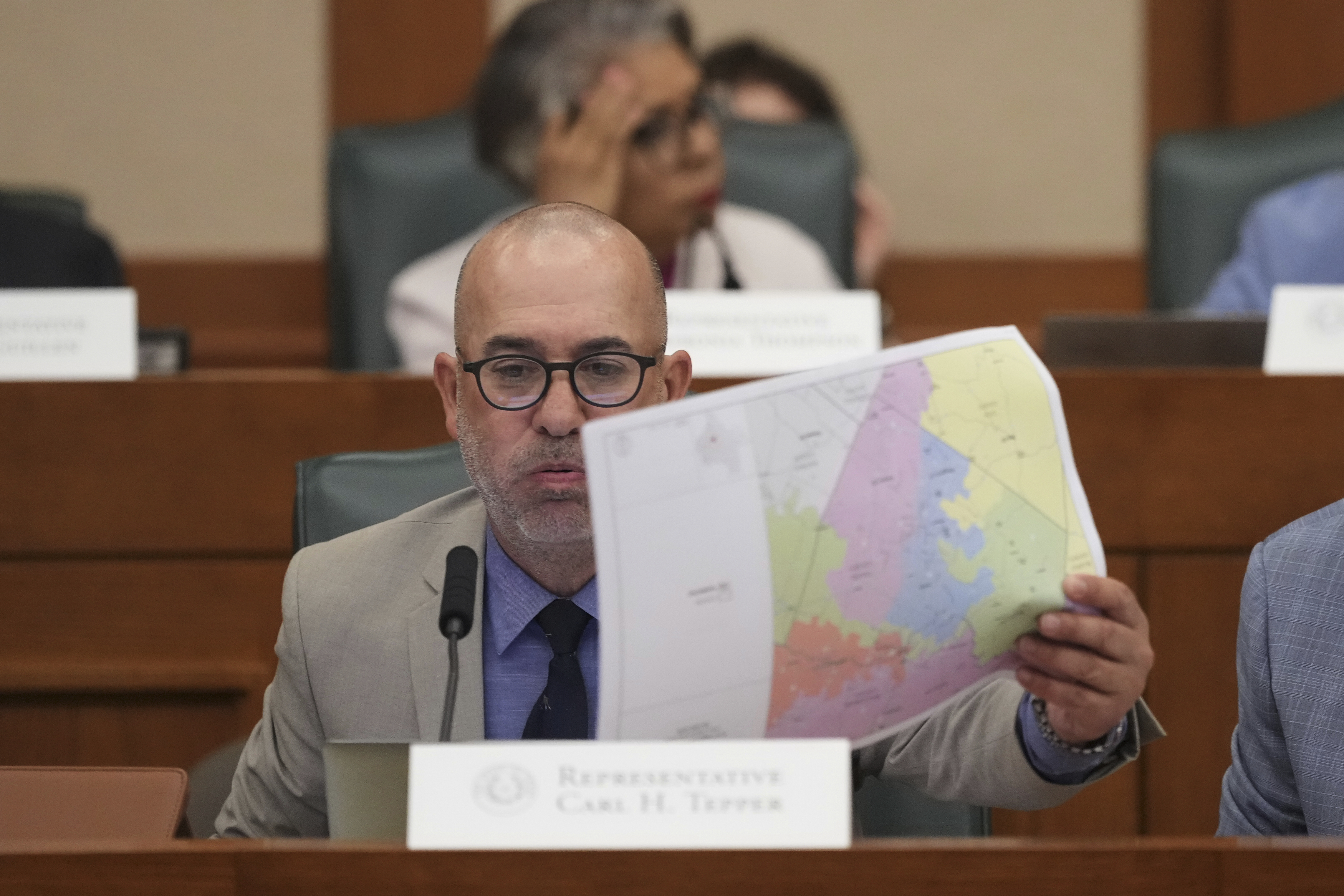 Texas state Rep. Carl H. Tepper, R-Lubbock, looks through U.S. Congressional District maps during a redistricting hearing at the Texas Capitol, Thursday, July 24, 2025, in Austin, Texas. (AP Photo/Eric Gay)