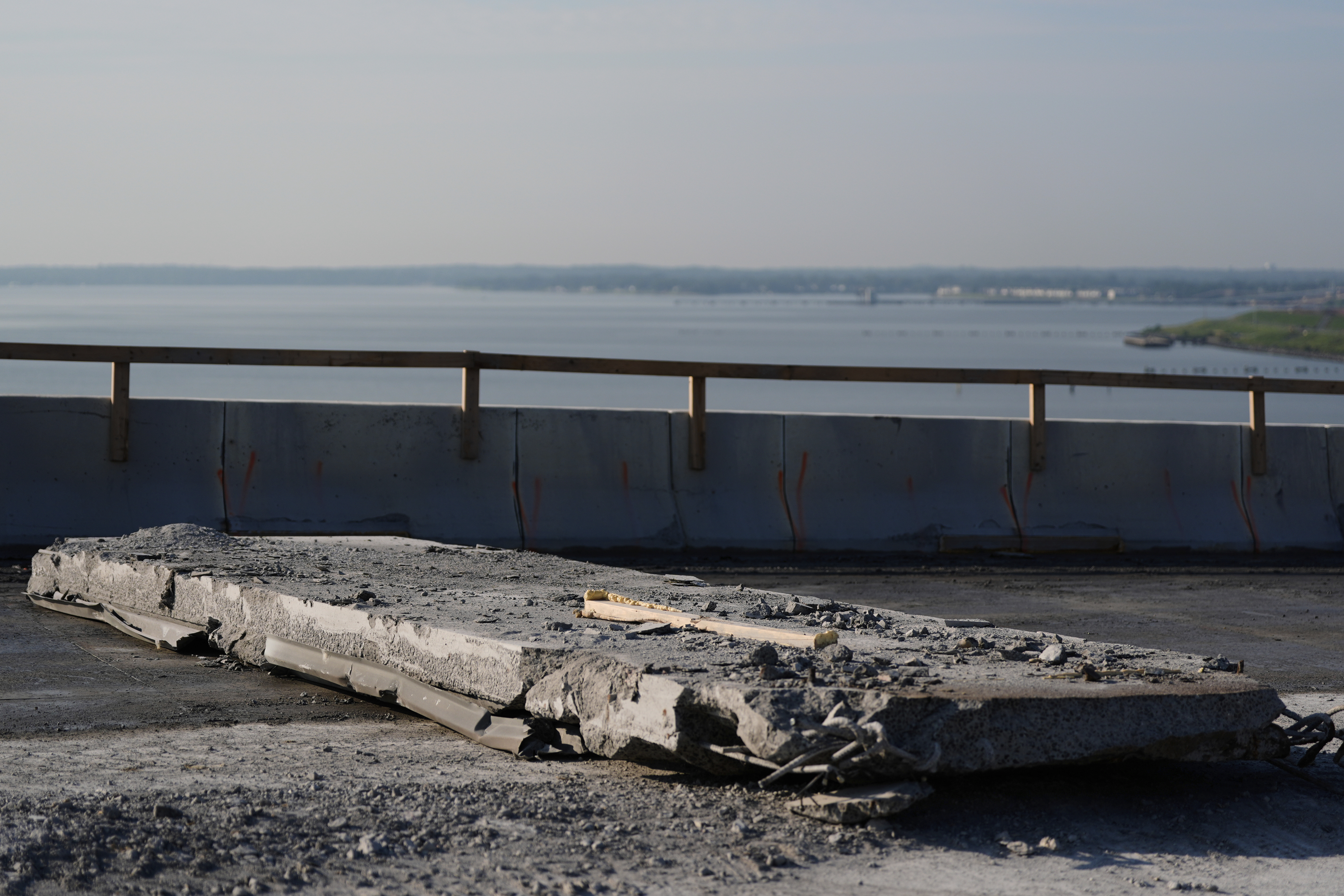 A slab of concrete is prepared to be removed from the remaining portions of the Francis Scott Key Bridge, Wednesday, July 30, 2025, in Baltimore. (AP Photo/Stephanie Scarbrough)