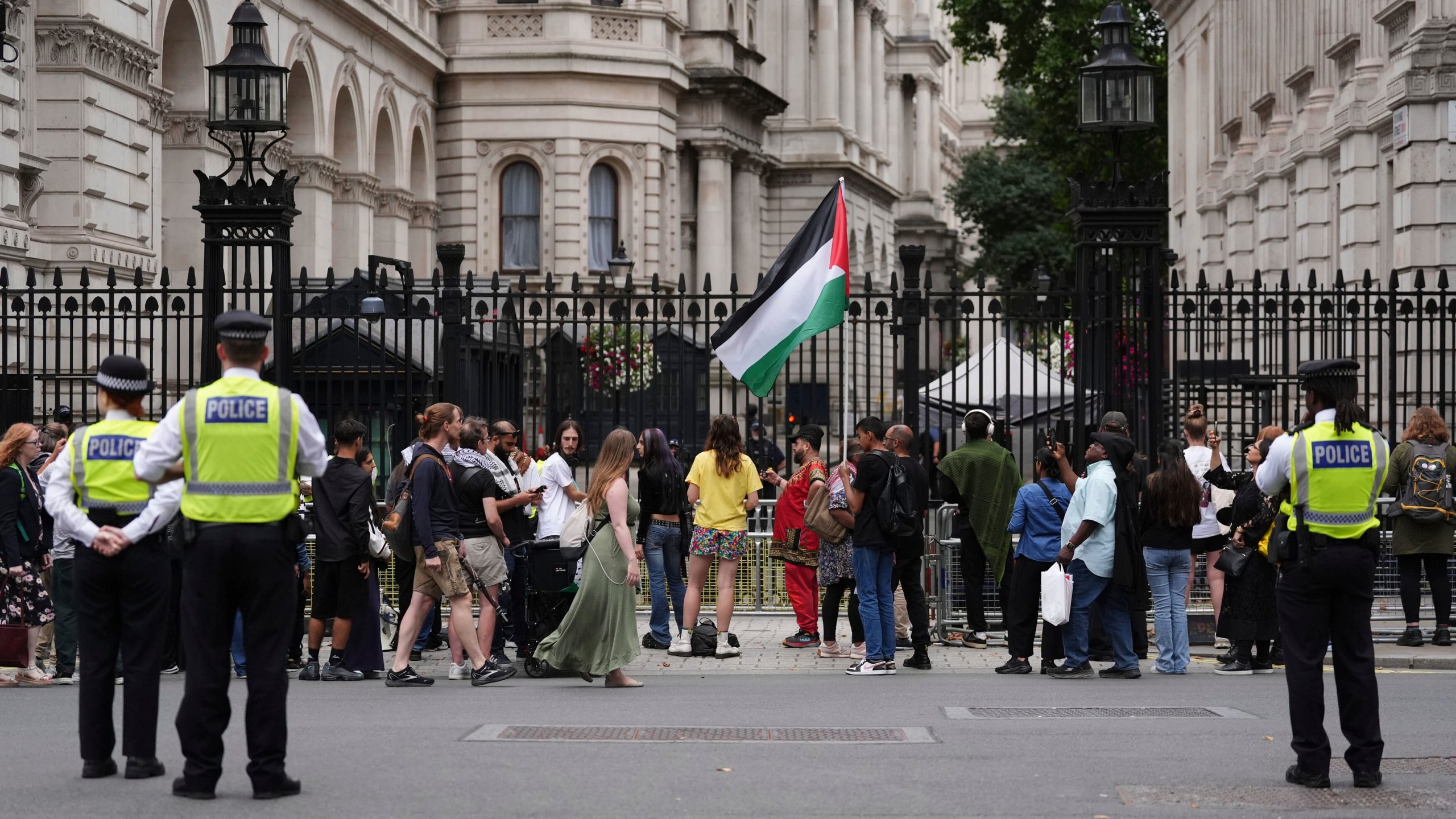 People take part in a protest outside Downing Street in London, Tuesday July 29, 2025, as Prime Minister Keir Starmer gathered senior ministers for an urgent Cabinet meeting on Gaza. (Jonathan Brady/PA via AP)