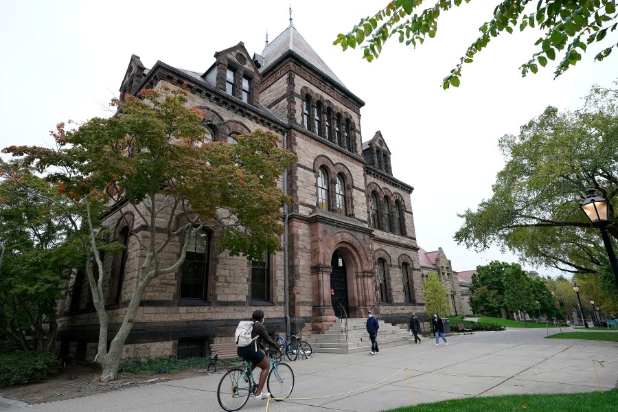FILE - People traverse Brown University campus in Providence, R.I., Oct. 12, 2020. (AP Photo/Steven Senne, File)