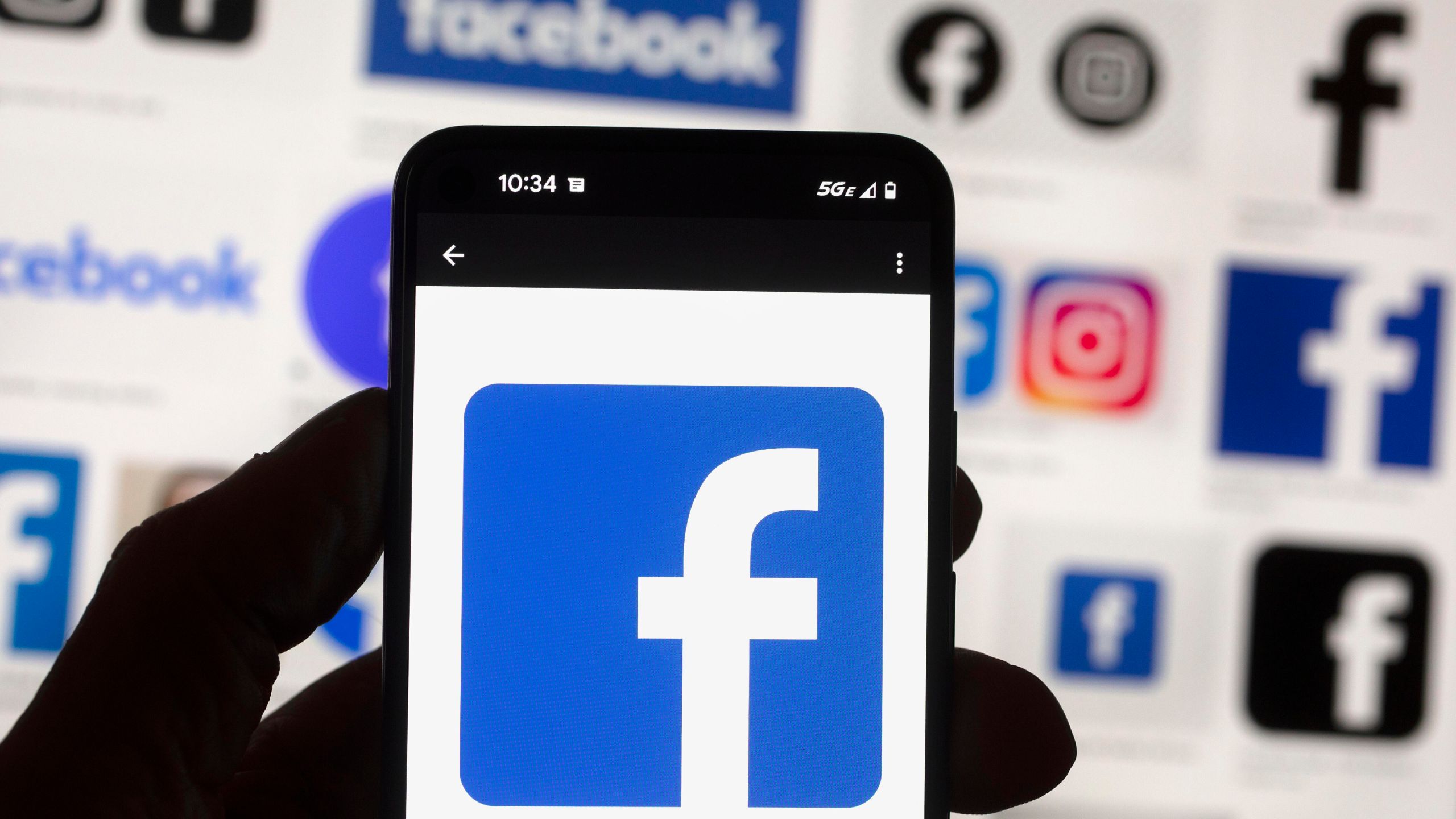 FILE - The Facebook logo is seen on a cell phone in Boston, USA, Oct. 14, 2022. (AP Photo/Michael Dwyer, File)