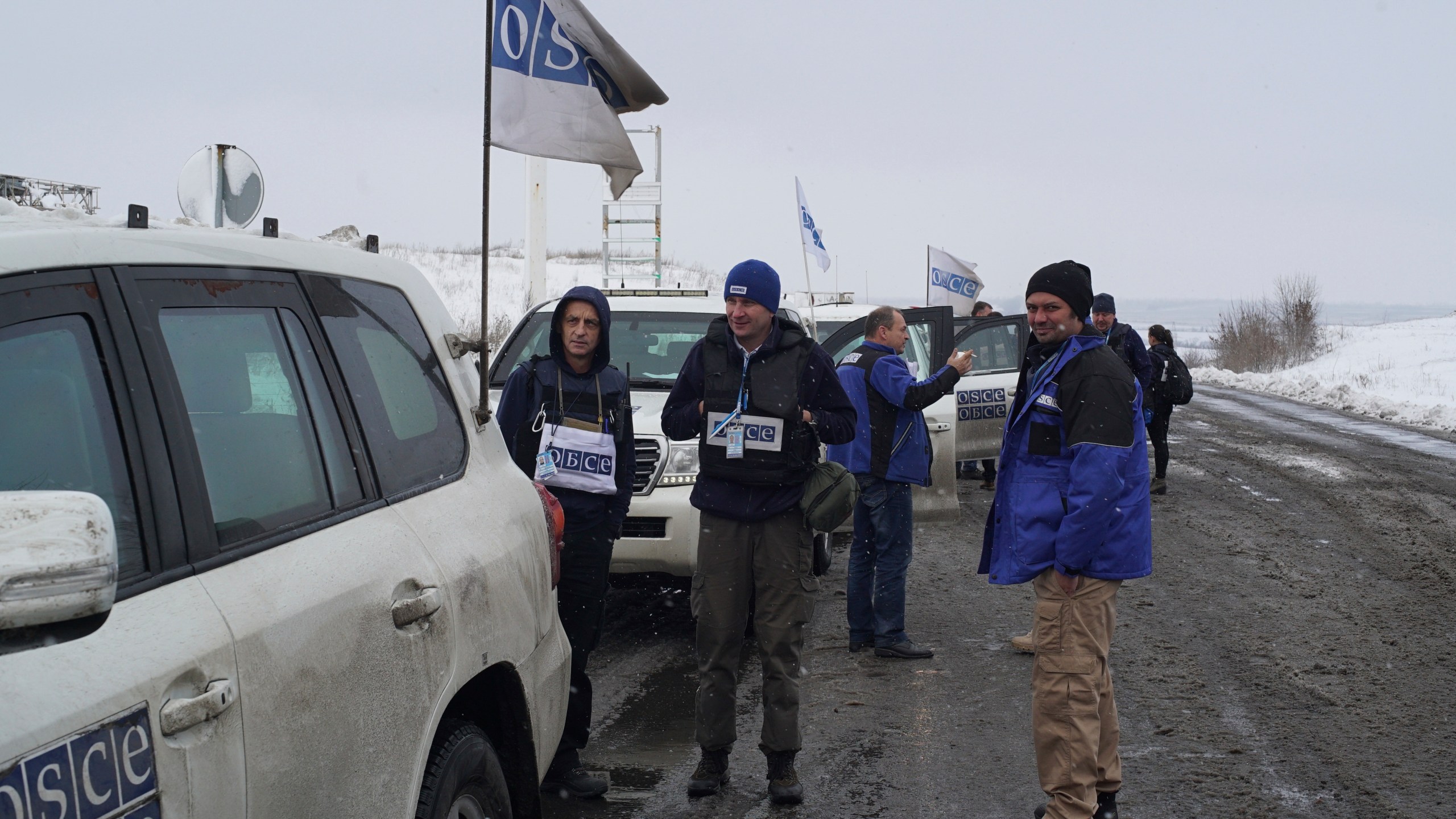 Organization for Security and Cooperation in Europe security assistant Vadym Golda, center, stands near his car during a patrol in the Donetsk region of Ukraine, Nov. 23, 2017. (AP Photo)