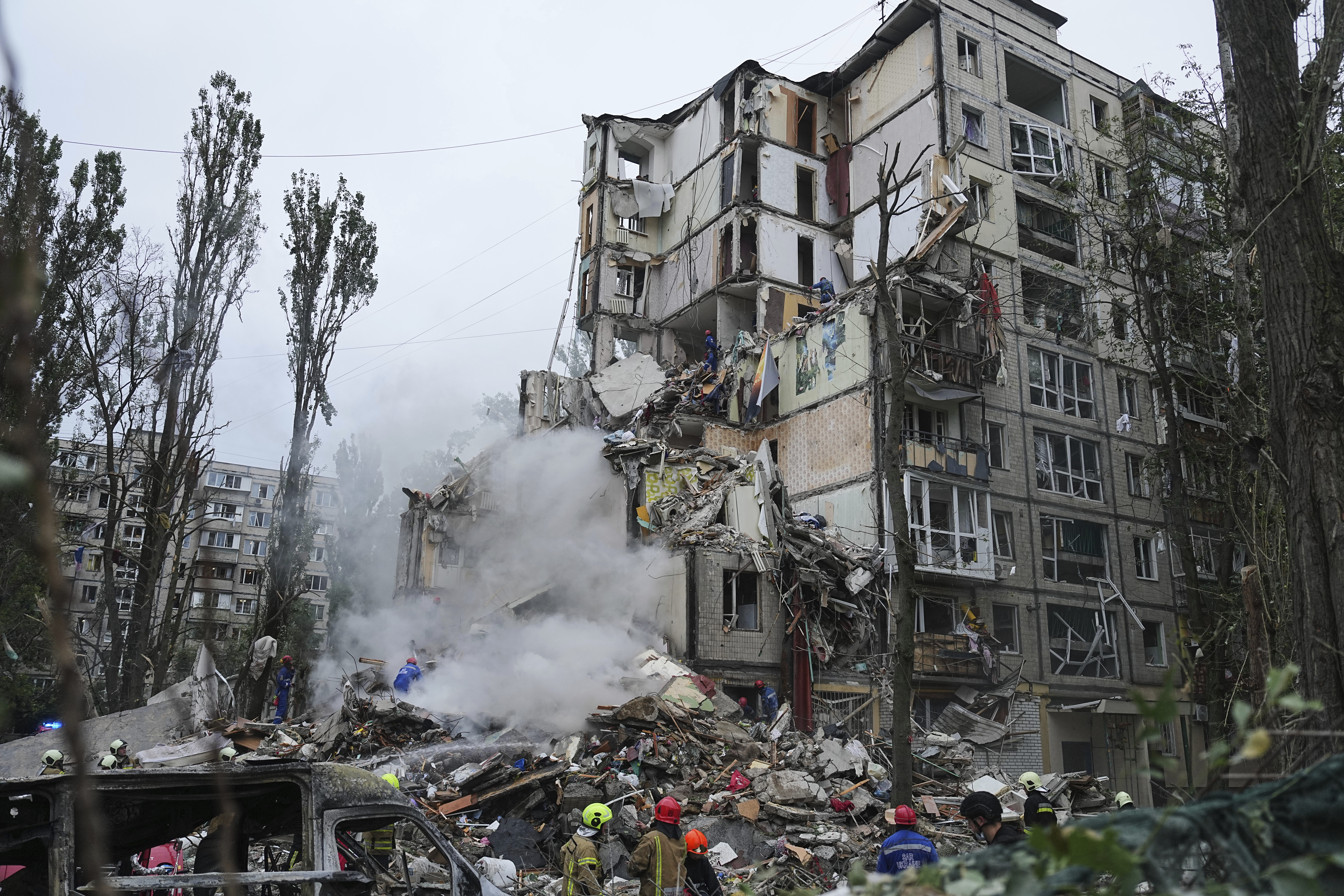 Rescuers work in a destroyed apartment building after a Russian missile attack in Kyiv, Ukraine, Thursday, July 31, 2025. (AP Photo/Efrem Lukatsky)