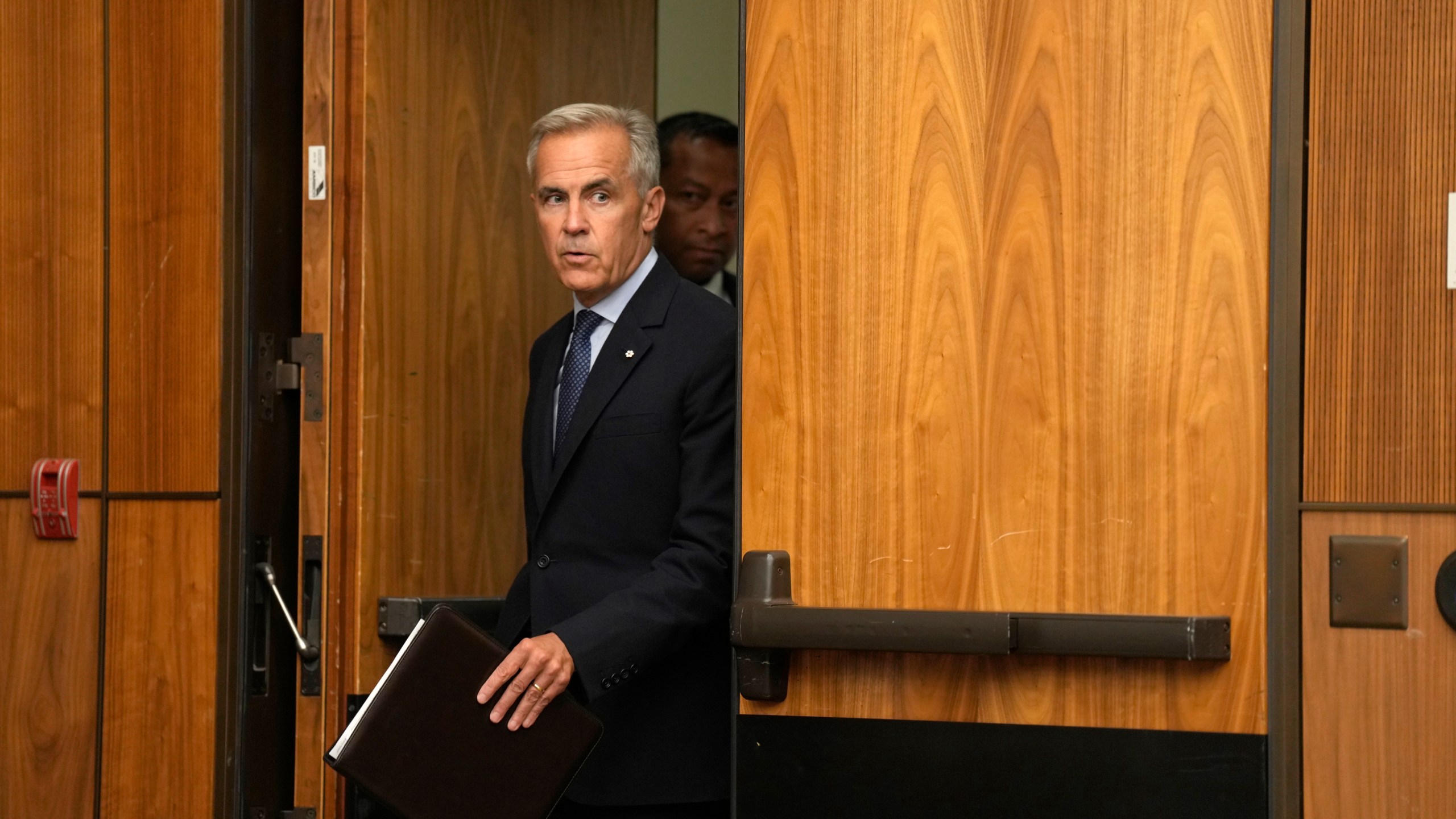 Canada Prime Minister Mark Carney arrives to speak with media during a news conference in Ottawa, Ontario, Wednesday, July 30, 2025. (Adrian Wyld/The Canadian Press via AP)