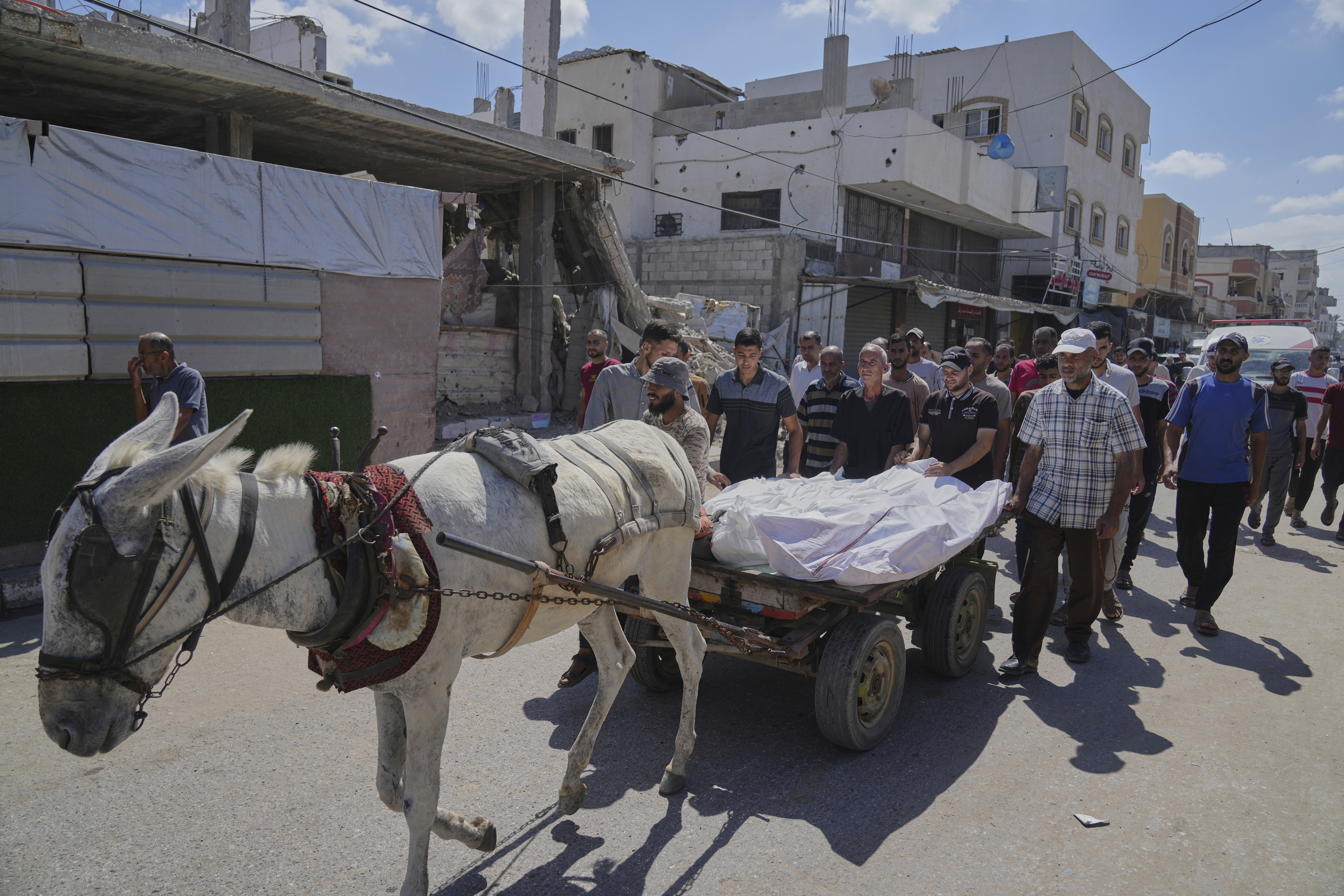 Mourners attend the funeral of their relatives killed in an Israeli bombardment, in Deir al-Balah, central Gaza Strip, Thursday, July 31, 2025. (AP Photo/Abdel Kareem Hana)