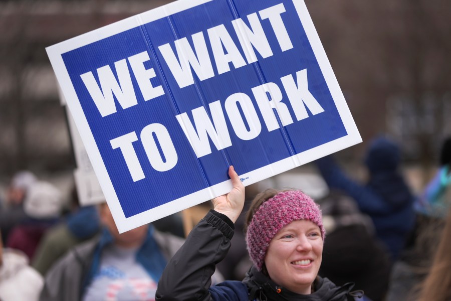 FILE - Katy Frank, a former computer scientist at the NOAA Great Lakes Environmental Research Lab, who lost her job Thursday, protests outside the John D. Dingell Veterans Affairs Medical Center in Detroit, Friday, Feb. 28, 2025. (AP Photo/Paul Sancya, File)