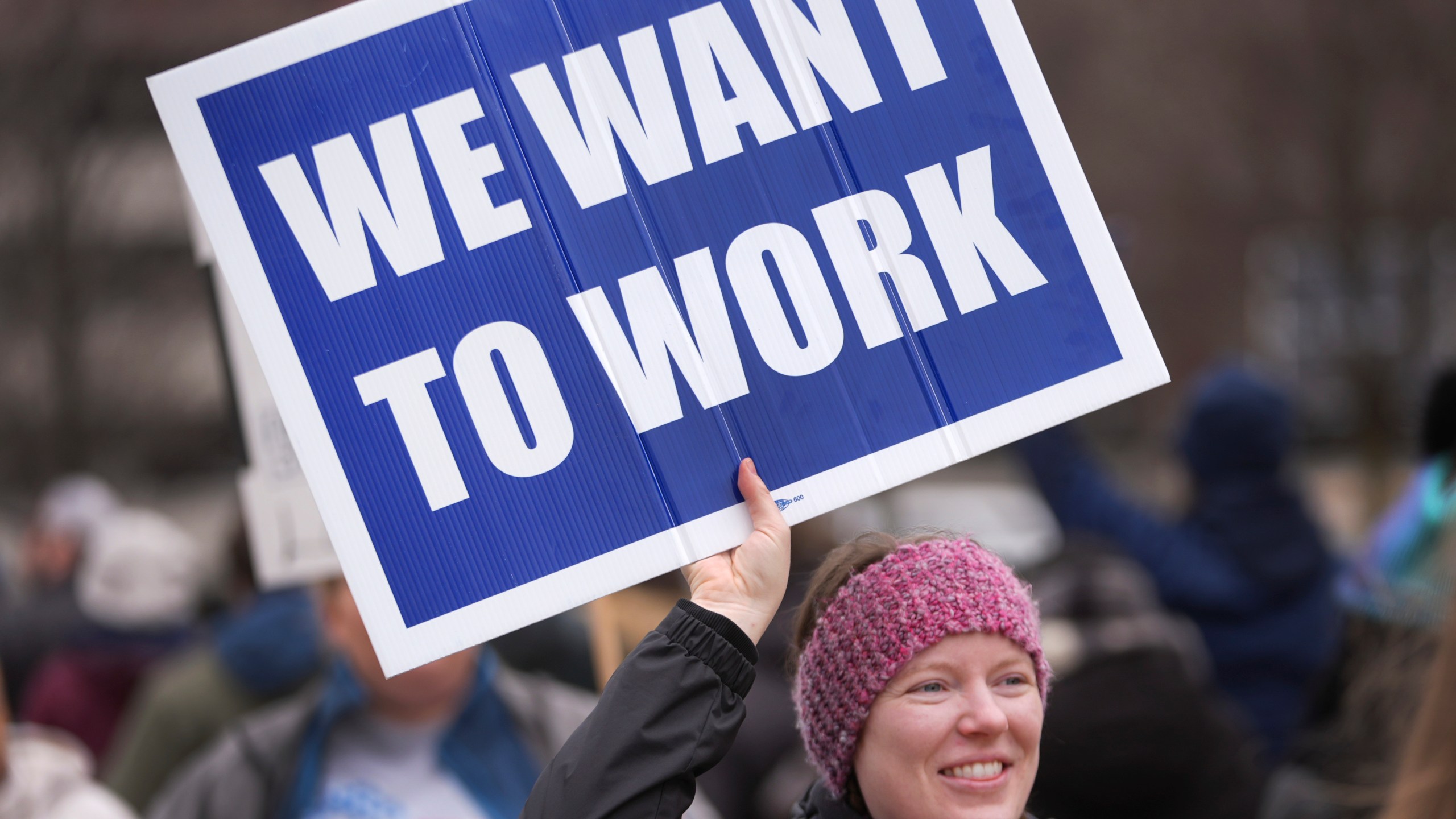 FILE - Katy Frank, a former computer scientist at the NOAA Great Lakes Environmental Research Lab, who lost her job Thursday, protests outside the John D. Dingell Veterans Affairs Medical Center in Detroit, Friday, Feb. 28, 2025. (AP Photo/Paul Sancya, File)