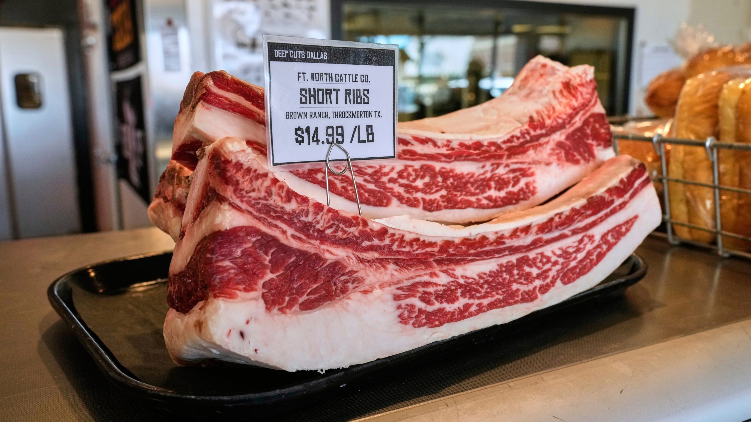 Several pounds of short ribs show the price per pound at Deep Cuts Dallas Butcher Shop, Thursday, July 24, 2025, in Dallas. (AP Photo/Tony Gutierrez)