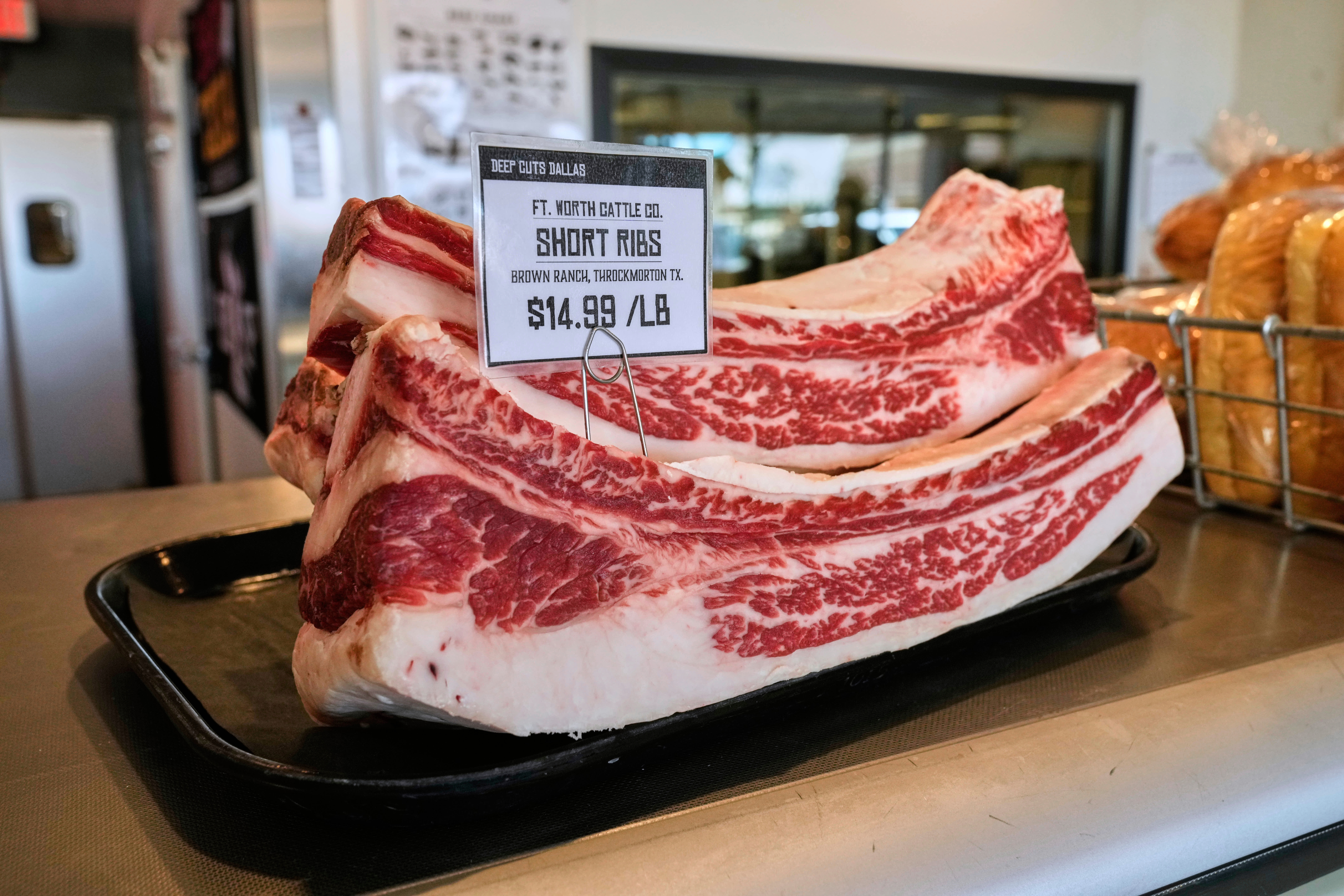 Several pounds of short ribs show the price per pound at Deep Cuts Dallas Butcher Shop, Thursday, July 24, 2025, in Dallas. (AP Photo/Tony Gutierrez)