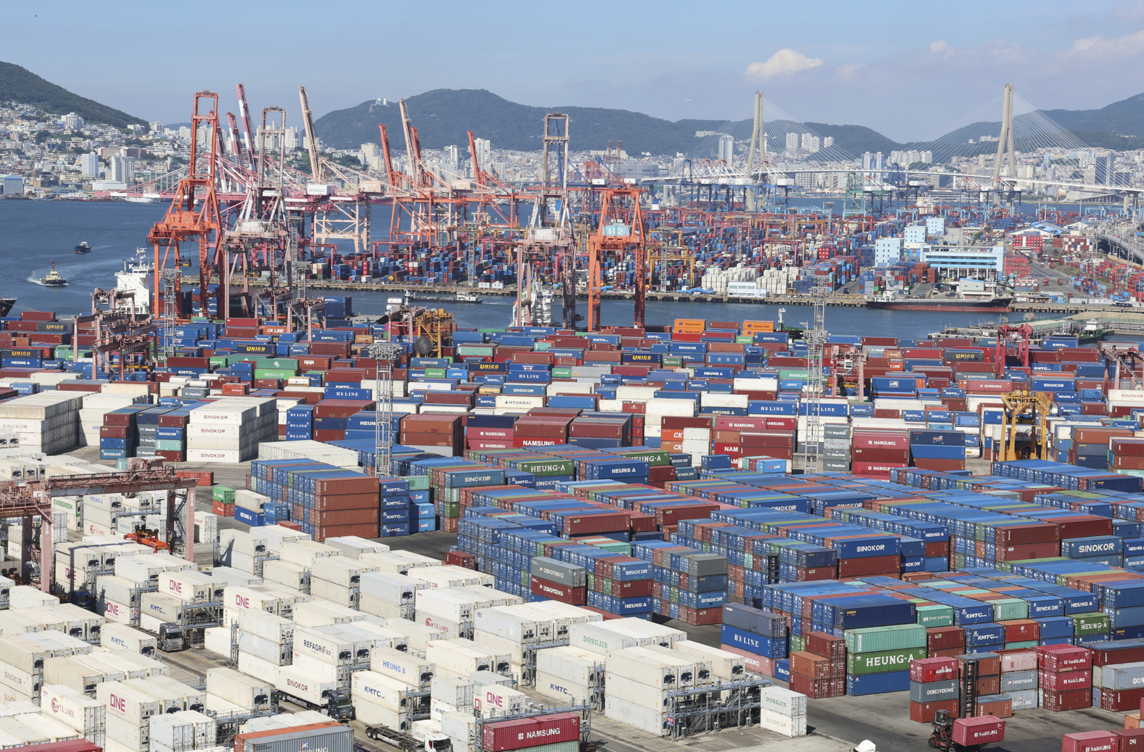 Cranes and shipping containers are seen at a port in Busan, South Korea, Thursday, July 31, 2025. (Gang Seon-bae/Yonhap via AP)