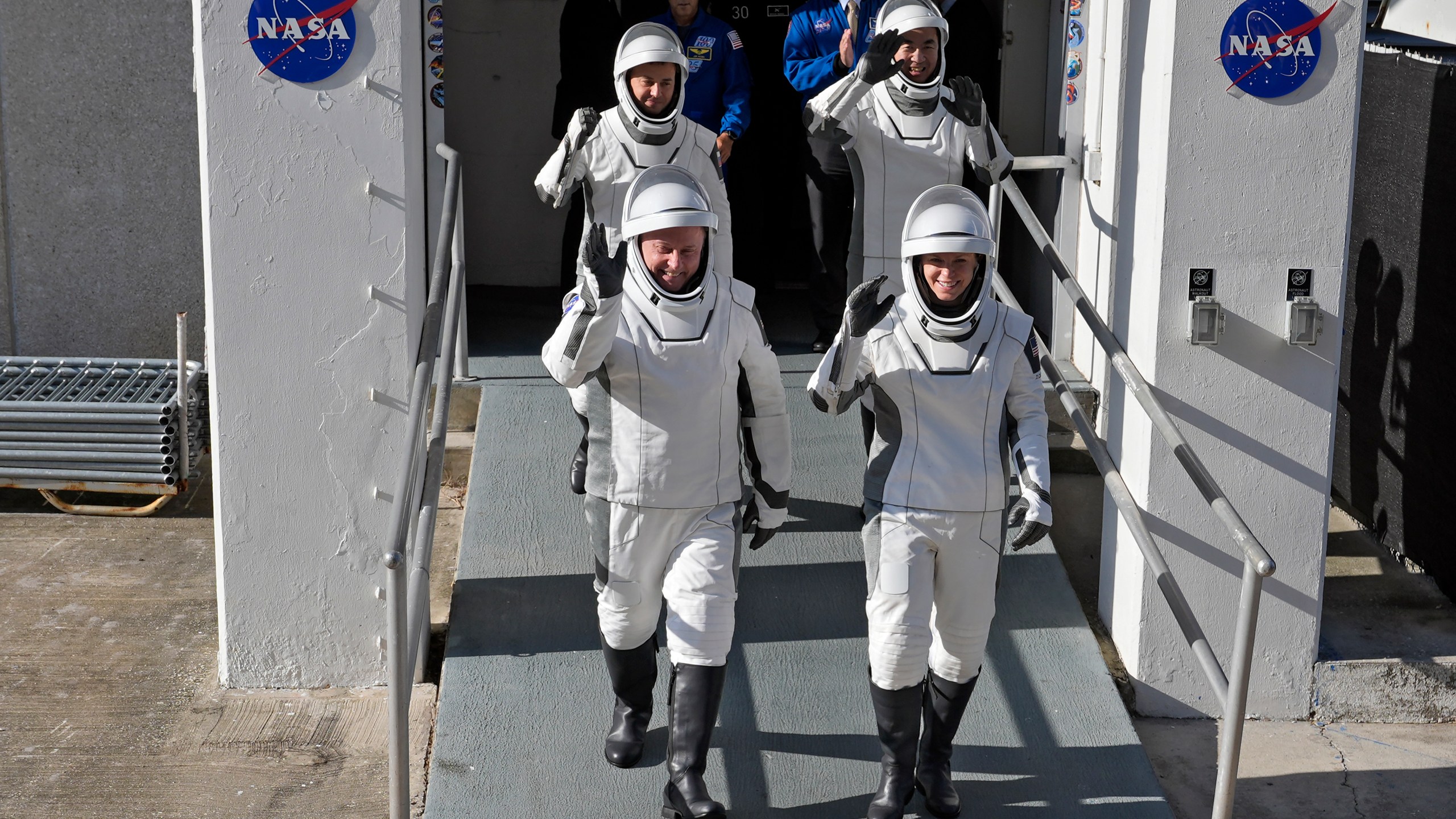 Astronauts, front row from left, Mike Fincke, of NASA, and Zena Cardman, of NASA, back row from left, Oleg Platonov, of Russia and Kimiya Yui, of Japan waves as they leave the Operations and Checkout Building for a trip the Kennedy Space Center's Launch Pad 39-A and a planned liftoff on a SpaceX Falcon 9 rocket Thursday, July 31, 2025, in Cape Canaveral , Fla. (AP Photo/John Raoux)