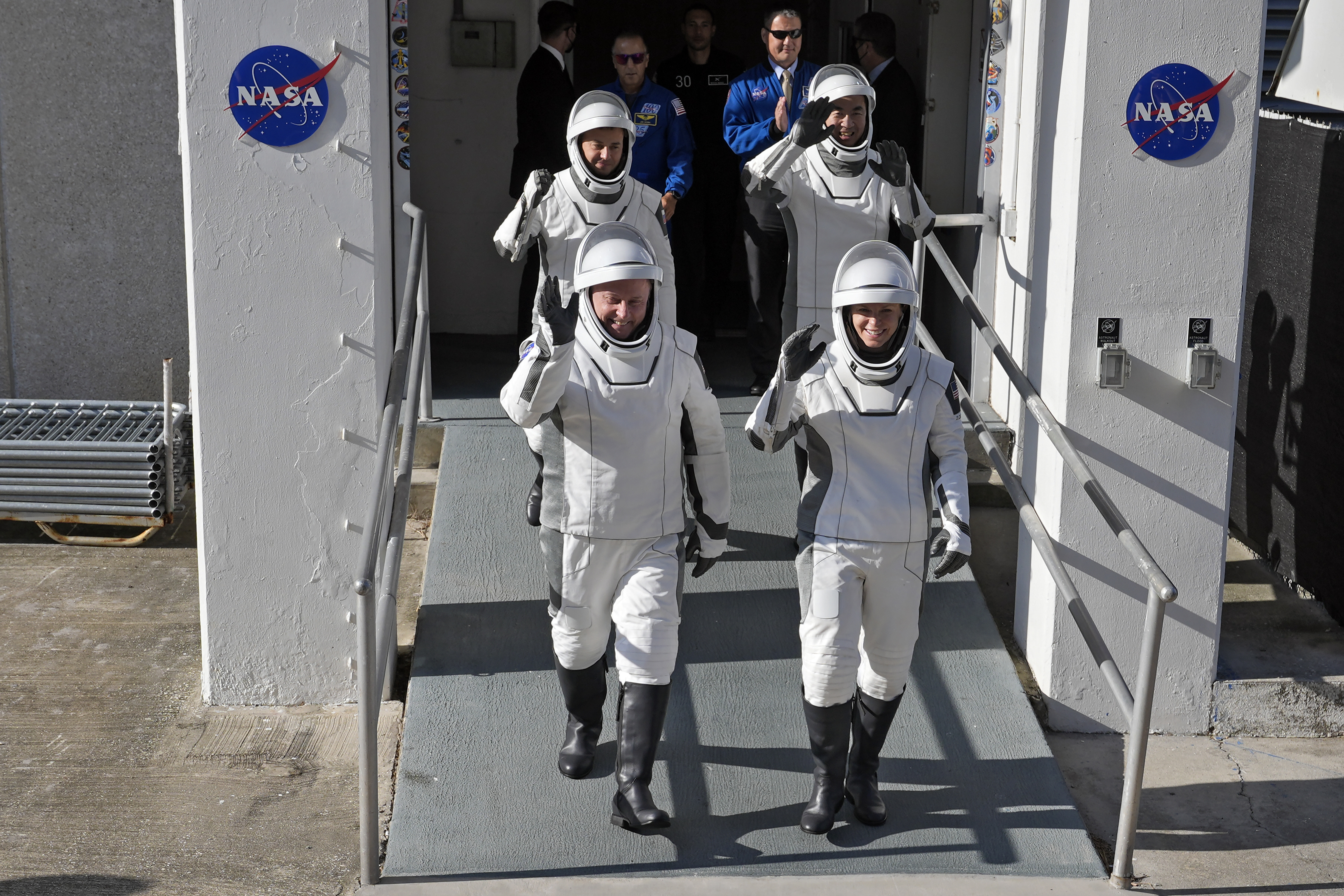 Astronauts, front row from left, Mike Fincke, of NASA, and Zena Cardman, of NASA, back row from left, Oleg Platonov, of Russia and Kimiya Yui, of Japan waves as they leave the Operations and Checkout Building for a trip the Kennedy Space Center's Launch Pad 39-A and a planned liftoff on a SpaceX Falcon 9 rocket Thursday, July 31, 2025, in Cape Canaveral , Fla. (AP Photo/John Raoux)