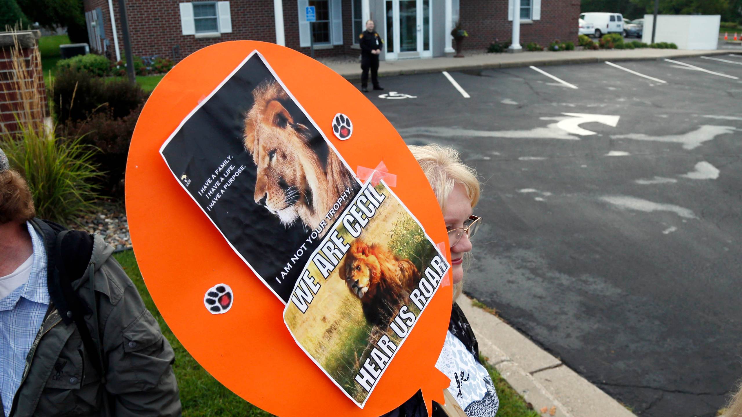 FILE - Demonstrators gather outside the dental practice of Walter Palmer, Sept. 8, 2015, in Bloomington, Minn. AP Photo/Jim Mone, File)
