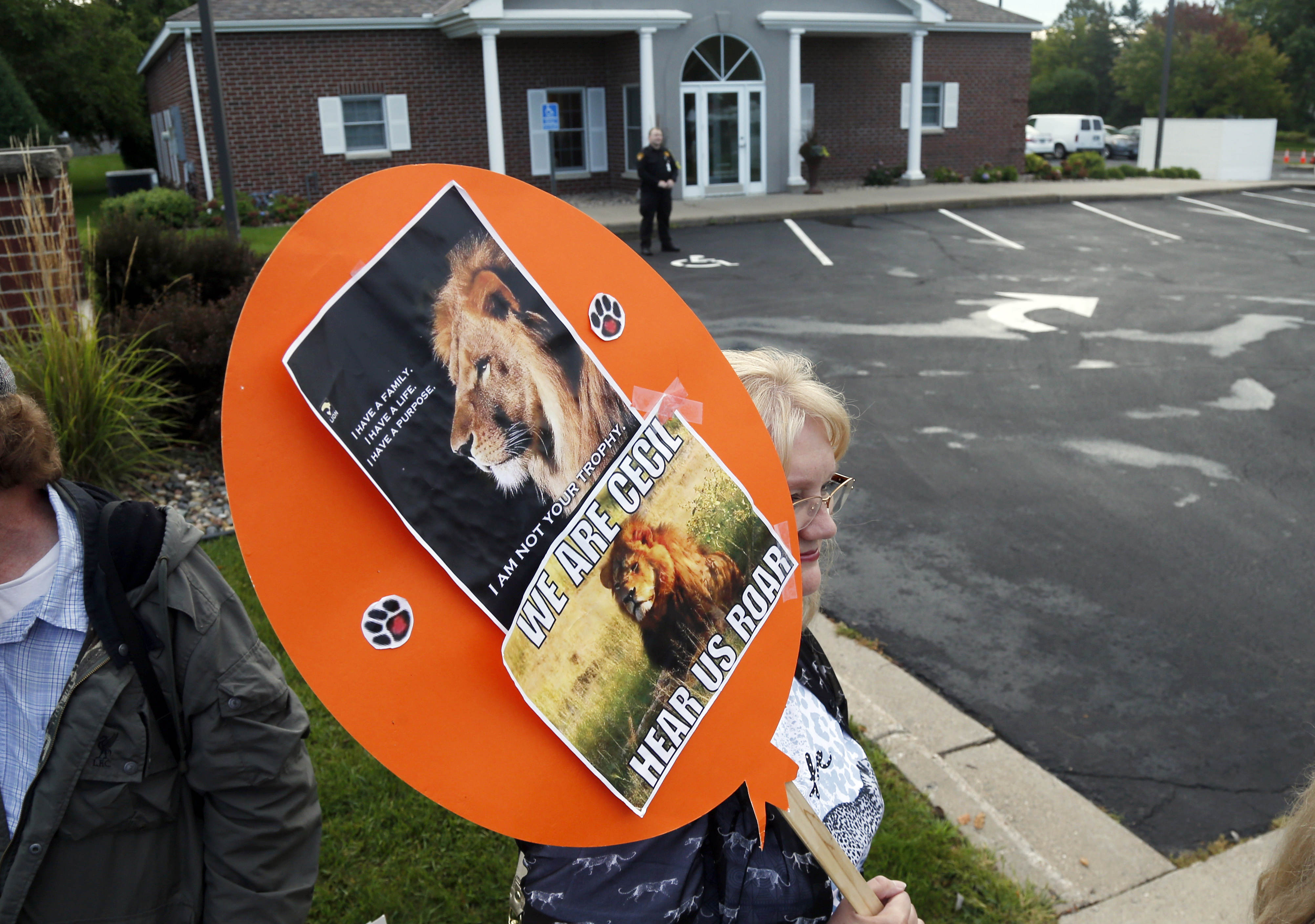 FILE - Demonstrators gather outside the dental practice of Walter Palmer, Sept. 8, 2015, in Bloomington, Minn. AP Photo/Jim Mone, File)