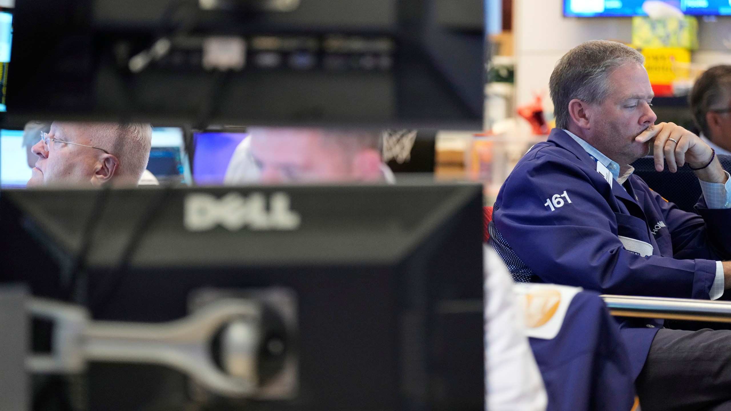 Traders work on the floor at the New York Stock Exchange in New York, Wednesday, July 30, 2025. (AP Photo/Seth Wenig)
