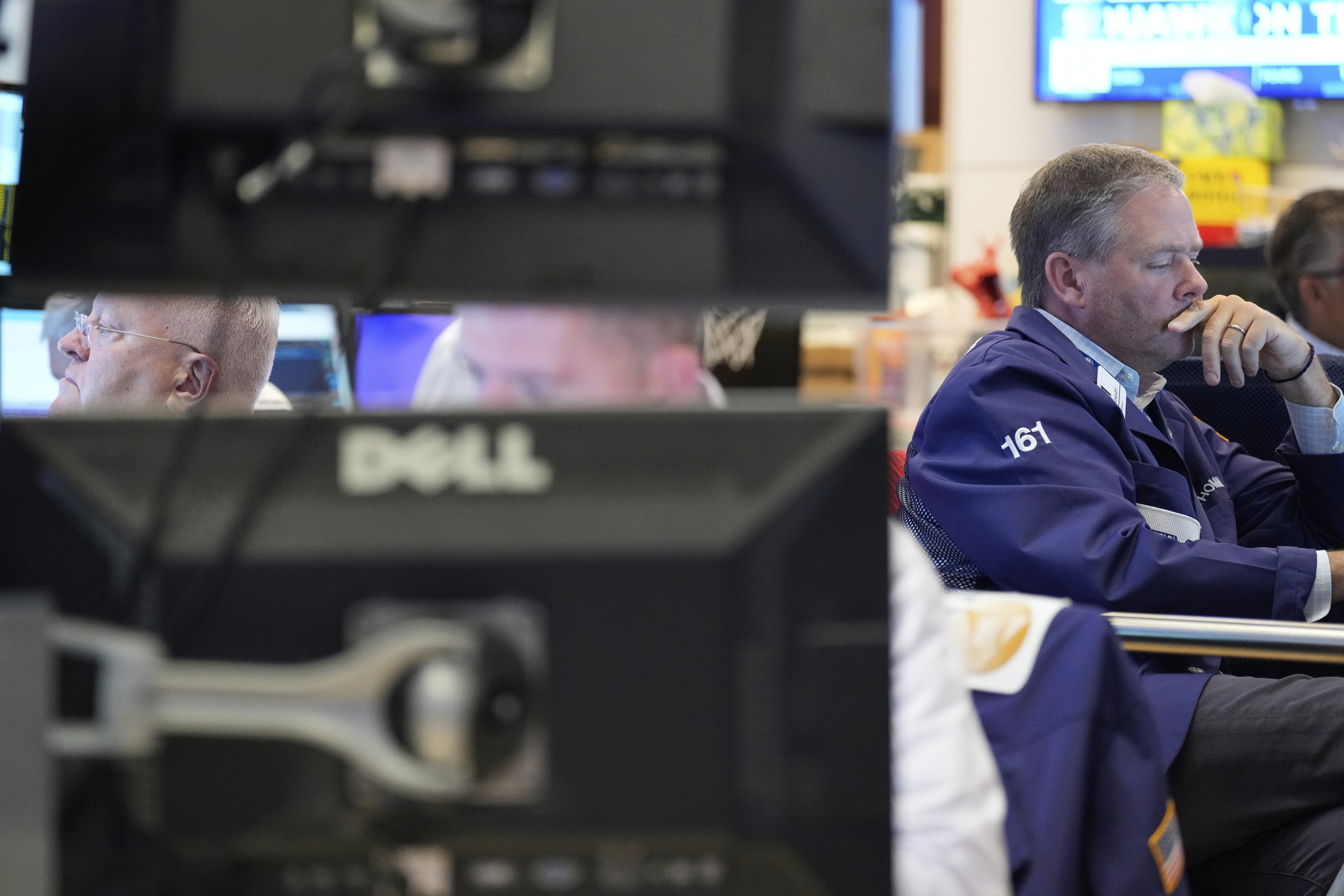 Traders work on the floor at the New York Stock Exchange in New York, Wednesday, July 30, 2025. (AP Photo/Seth Wenig)