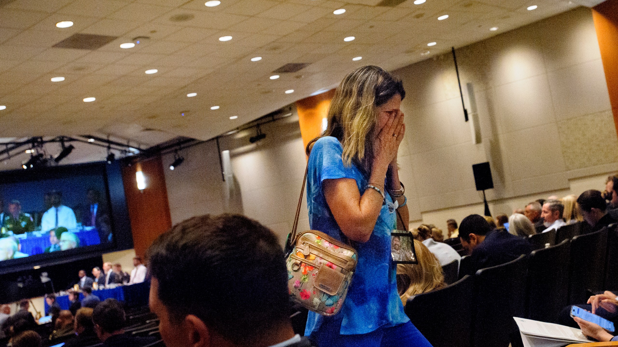 Christina Stovall, whose son, Mikey Stovall, died on American Airlines flight 5342 in a collision with a U.S. military helicopter, weeps as she leaves the room during the NTSB fact-finding hearing on the DCA midair collision accident, at the National Transportation and Safety Board boardroom, Wednesday, July 30, 2025, in Washington. (AP Photo/Rod Lamkey, Jr.)