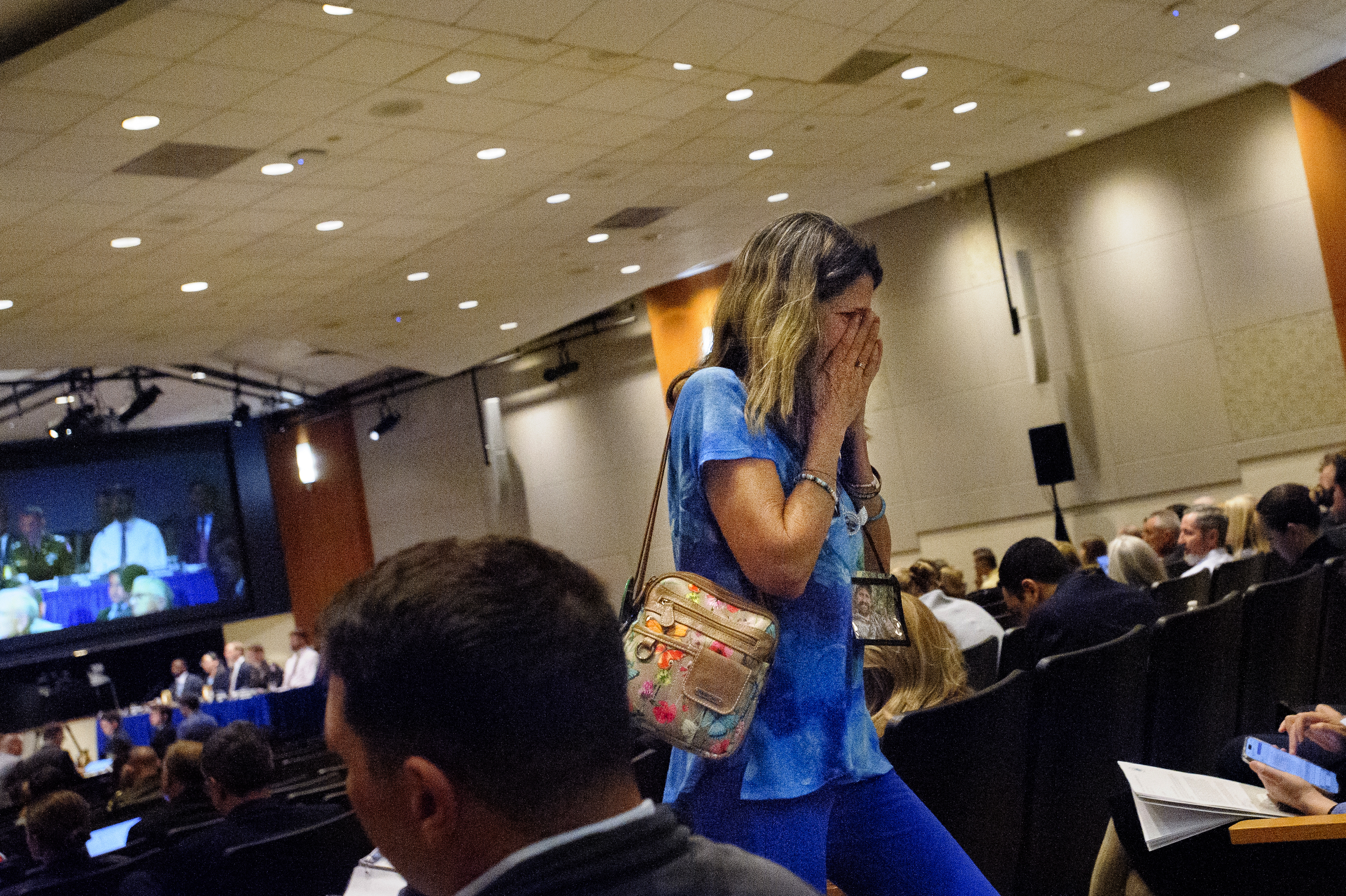 Christina Stovall, whose son, Mikey Stovall, died on American Airlines flight 5342 in a collision with a U.S. military helicopter, weeps as she leaves the room during the NTSB fact-finding hearing on the DCA midair collision accident, at the National Transportation and Safety Board boardroom, Wednesday, July 30, 2025, in Washington. (AP Photo/Rod Lamkey, Jr.)