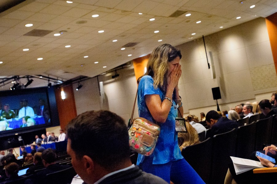 Christina Stovall, whose son, Mikey Stovall, died on American Airlines flight 5342 in a collision with a U.S. military helicopter, weeps as she leaves the room during the NTSB fact-finding hearing on the DCA midair collision accident, at the National Transportation and Safety Board boardroom, Wednesday, July 30, 2025, in Washington. (AP Photo/Rod Lamkey, Jr.)