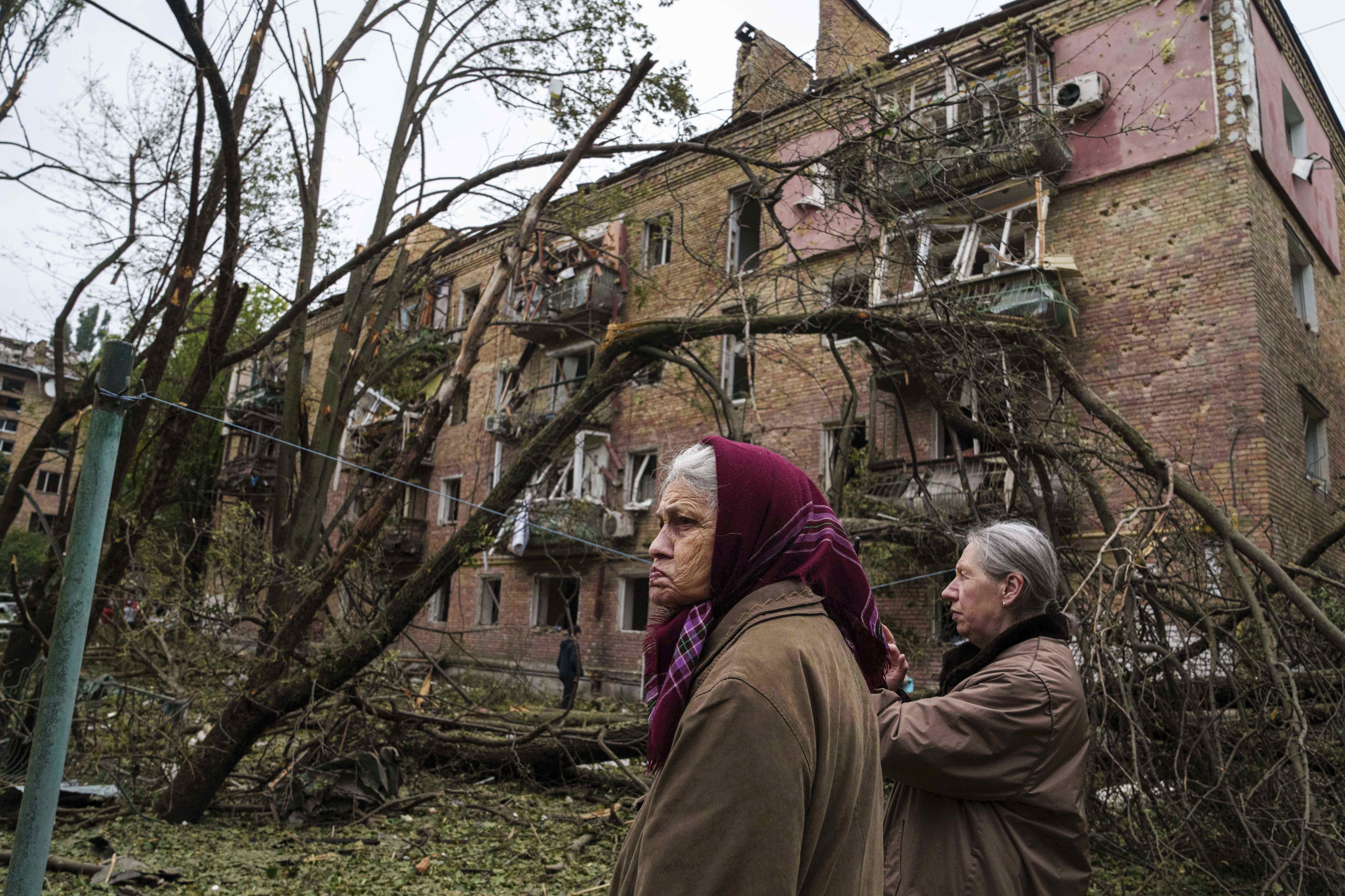 Local women stand in front of a residential building heavily damaged by a Russian strike in Kyiv, Ukraine, on Thursday, July 31, 2025. (AP Photo/Evgeniy Maloletka)