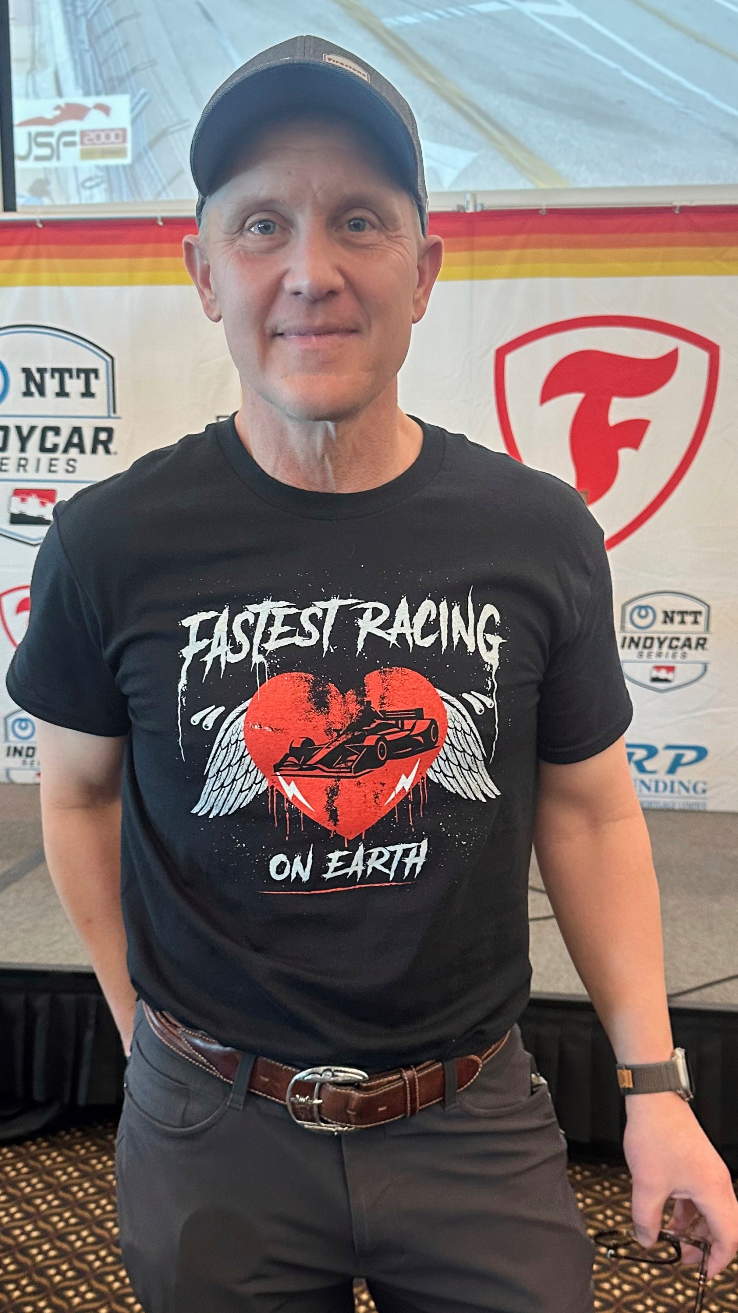 FILE - FOX Sports CEO & Executive Producer Eric Shanks poses in a T-shirt he designed to promote the IndyCar auto racing season on March 4, 2025, in St. Petersburg, Fla. (AP Photo/Jenna Fryer, File)
