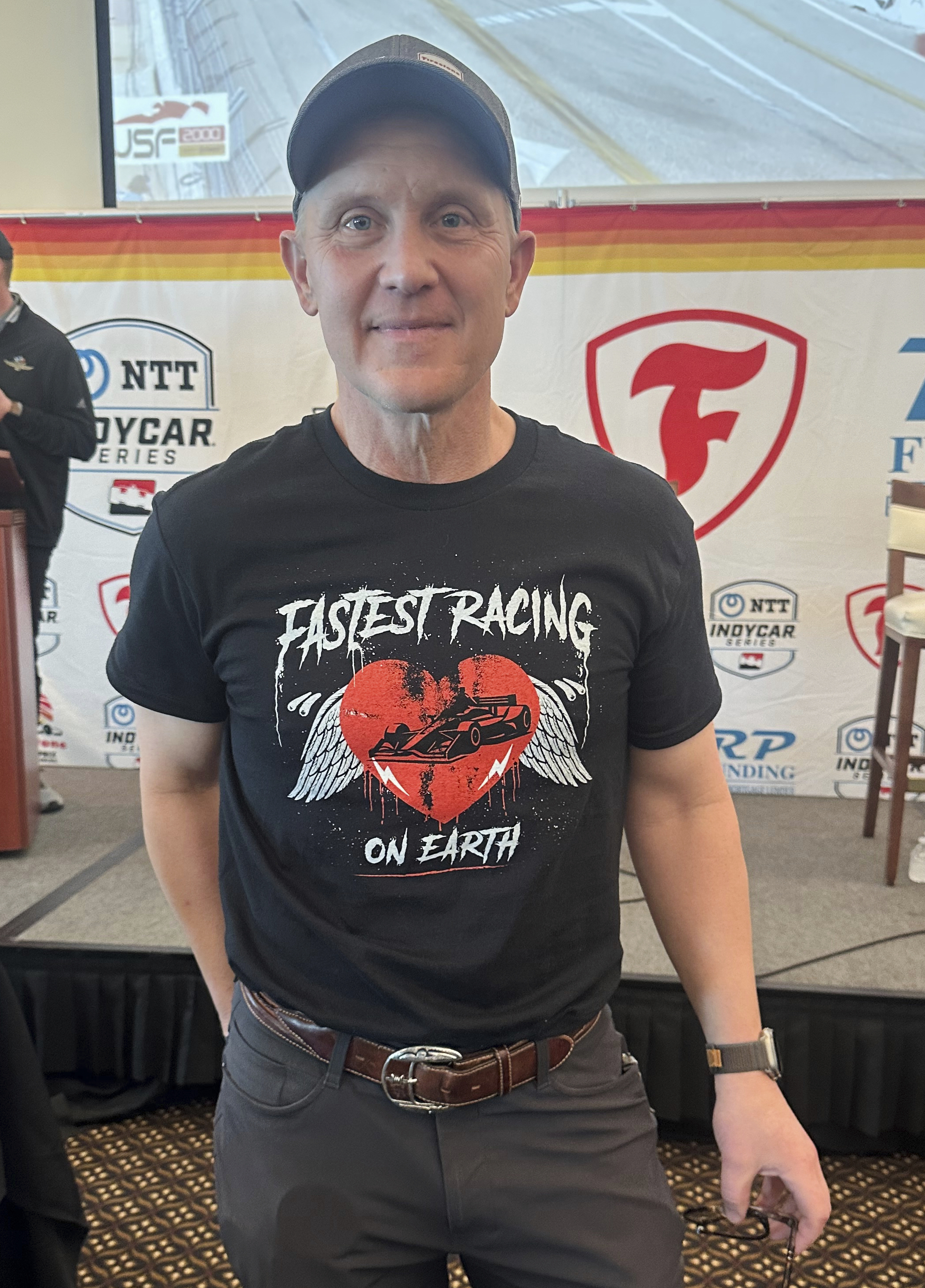 FILE - FOX Sports CEO & Executive Producer Eric Shanks poses in a T-shirt he designed to promote the IndyCar auto racing season on March 4, 2025, in St. Petersburg, Fla. (AP Photo/Jenna Fryer, File)