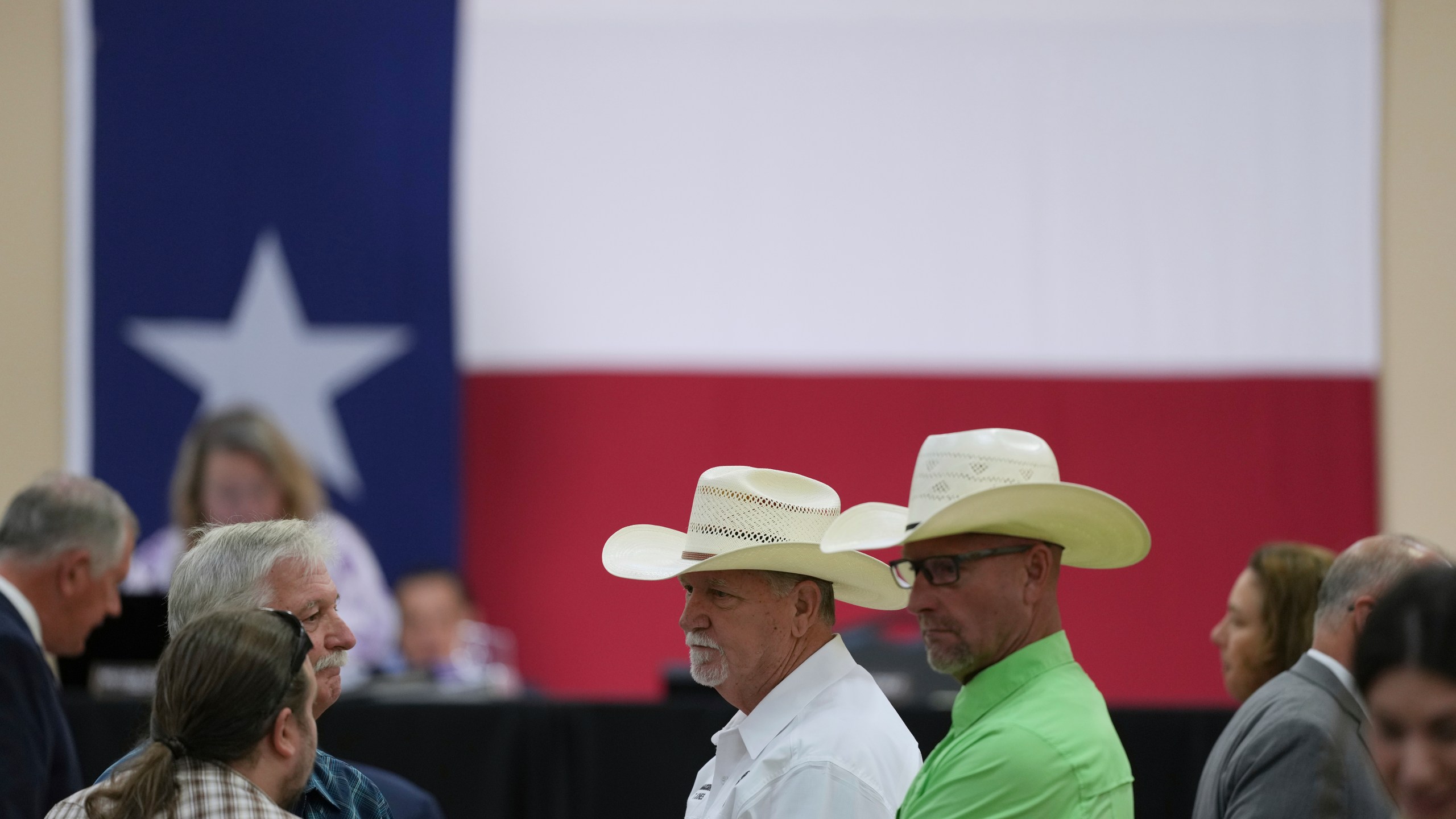 Attendees wait for a Senate and House Select Committees on Disaster Preparedness and Flooding public hearing to begin, in Kerrville, Texas, Thursday, July 31, 2025. (AP Photo/Eric Gay)